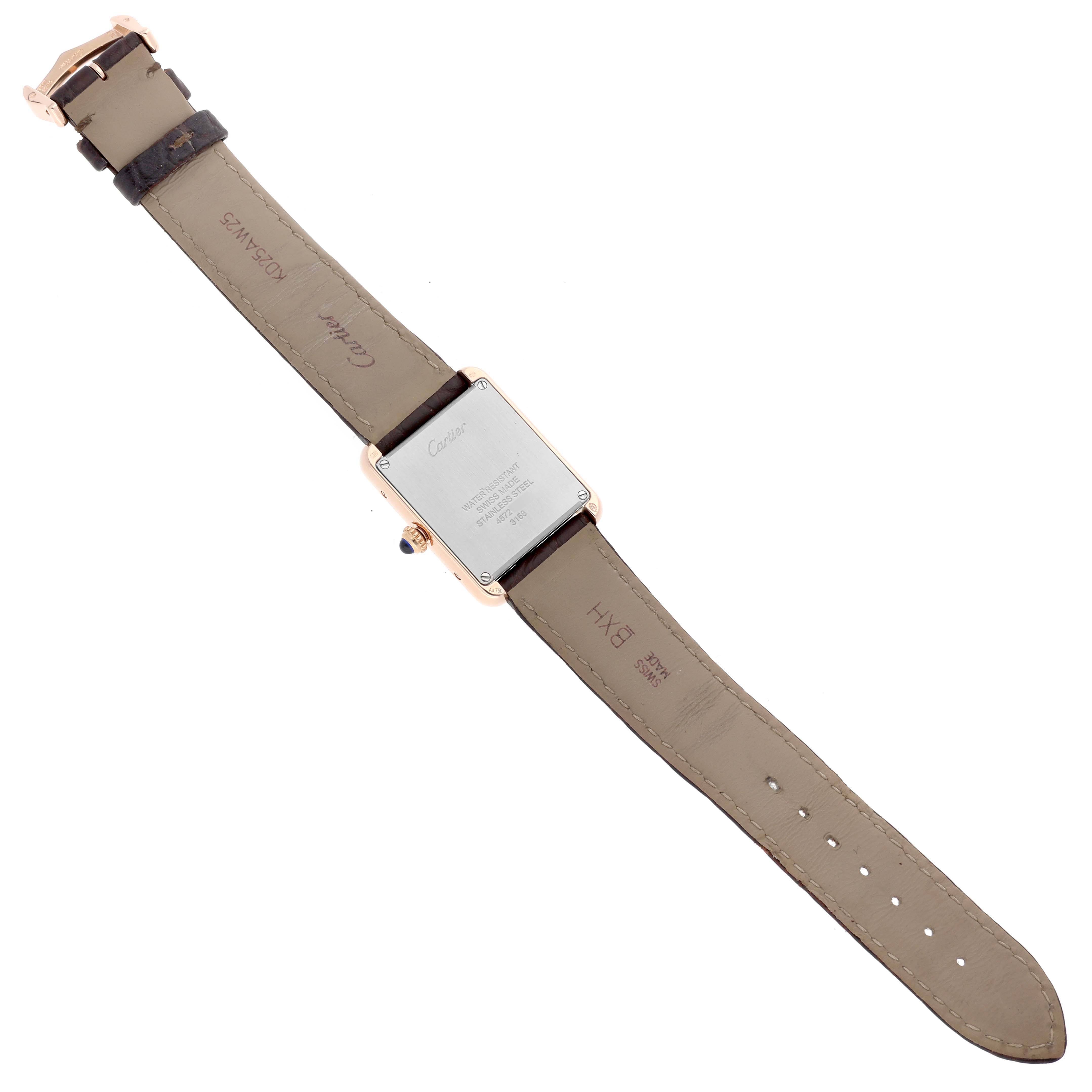 The image shows the Cartier Tank Solo W5200002 Women
s Steel and Gold (two tone) Silver Dial watch from the back, highlighting the case back and leather strap.