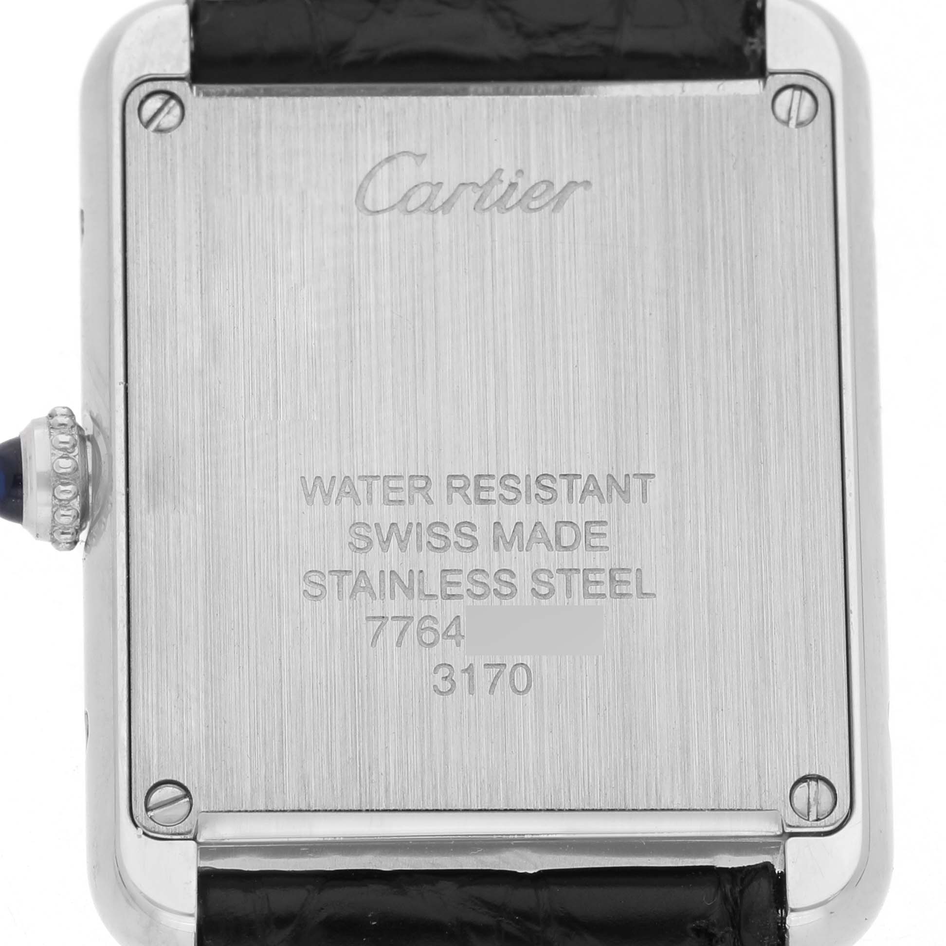 The image shows the back of a Cartier Tank Solo W5200005 Women's Stainless Steel Silver Dial watch, featuring engravings and part of the strap.