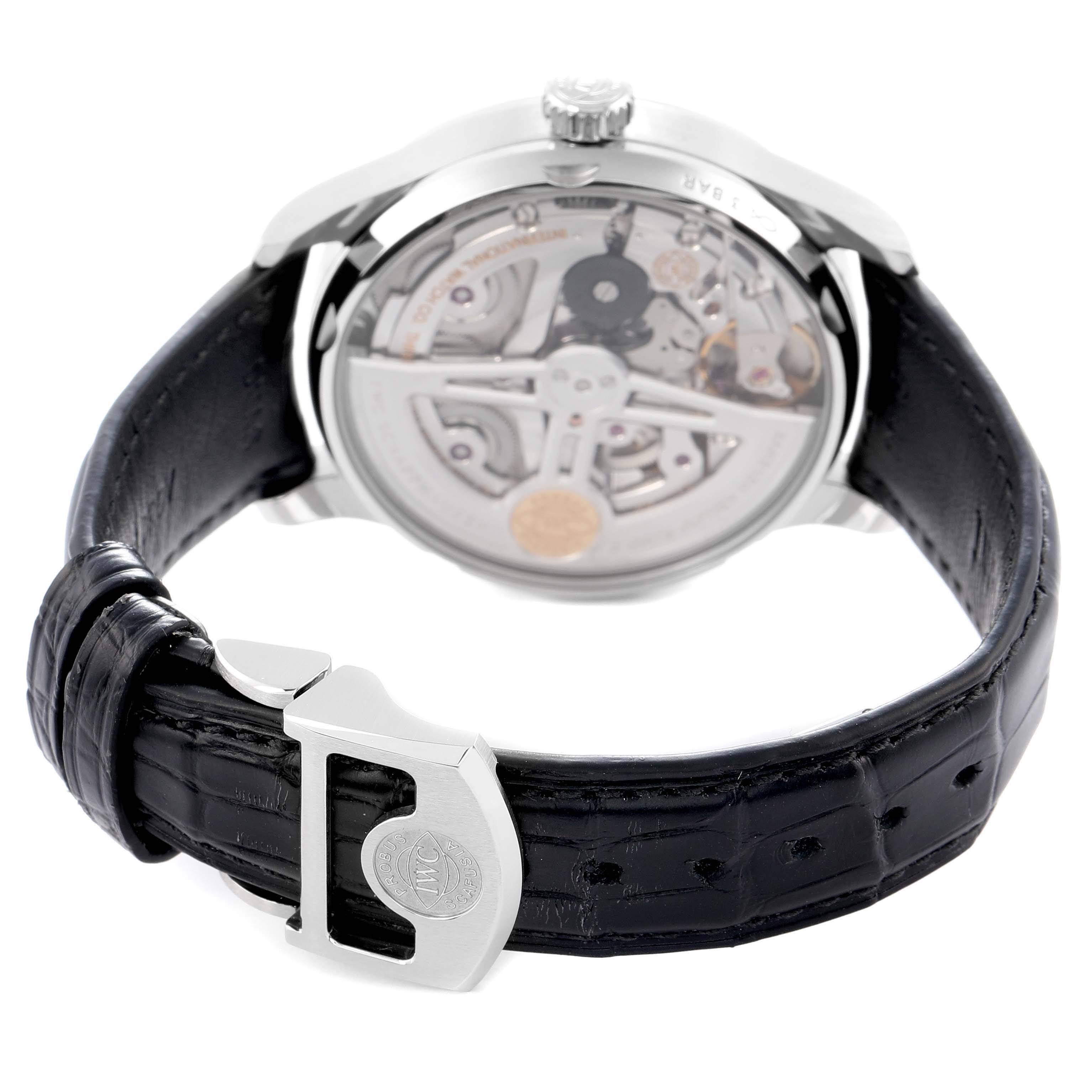 The IWC Portuguese IW500712 Men
s Stainless Steel Silver Dial watch is shown from the back, highlighting the transparent case back and the clasp of the leather strap.