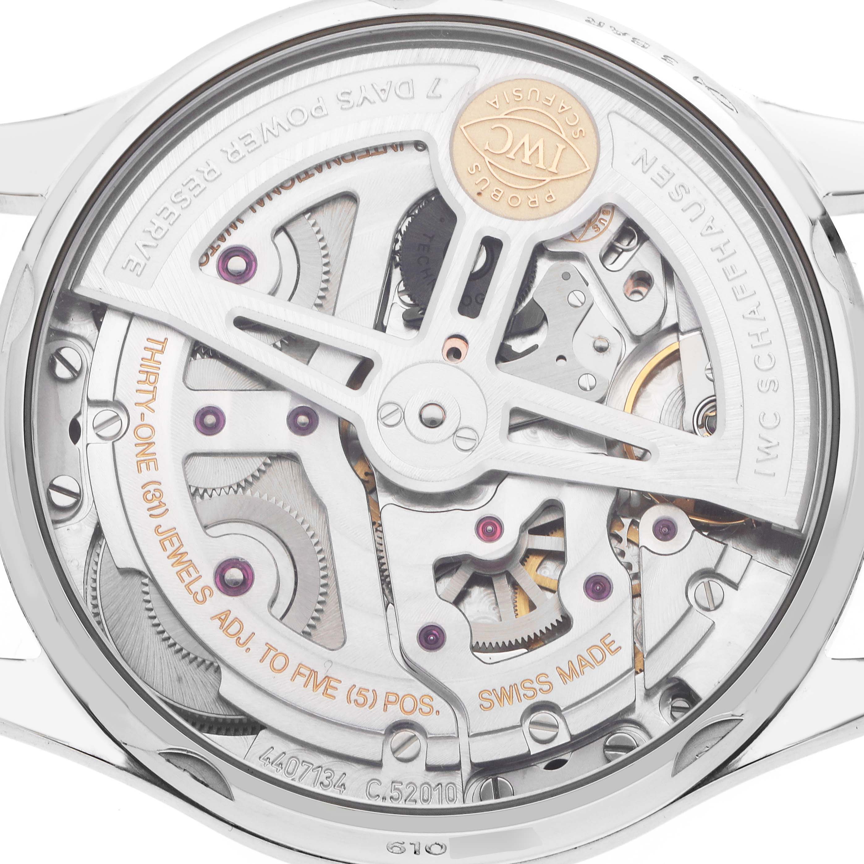 The image shows the back view of an IWC Portuguese IW500712 Men
s Stainless Steel Silver Dial watch, highlighting its intricate movement and mechanical components.