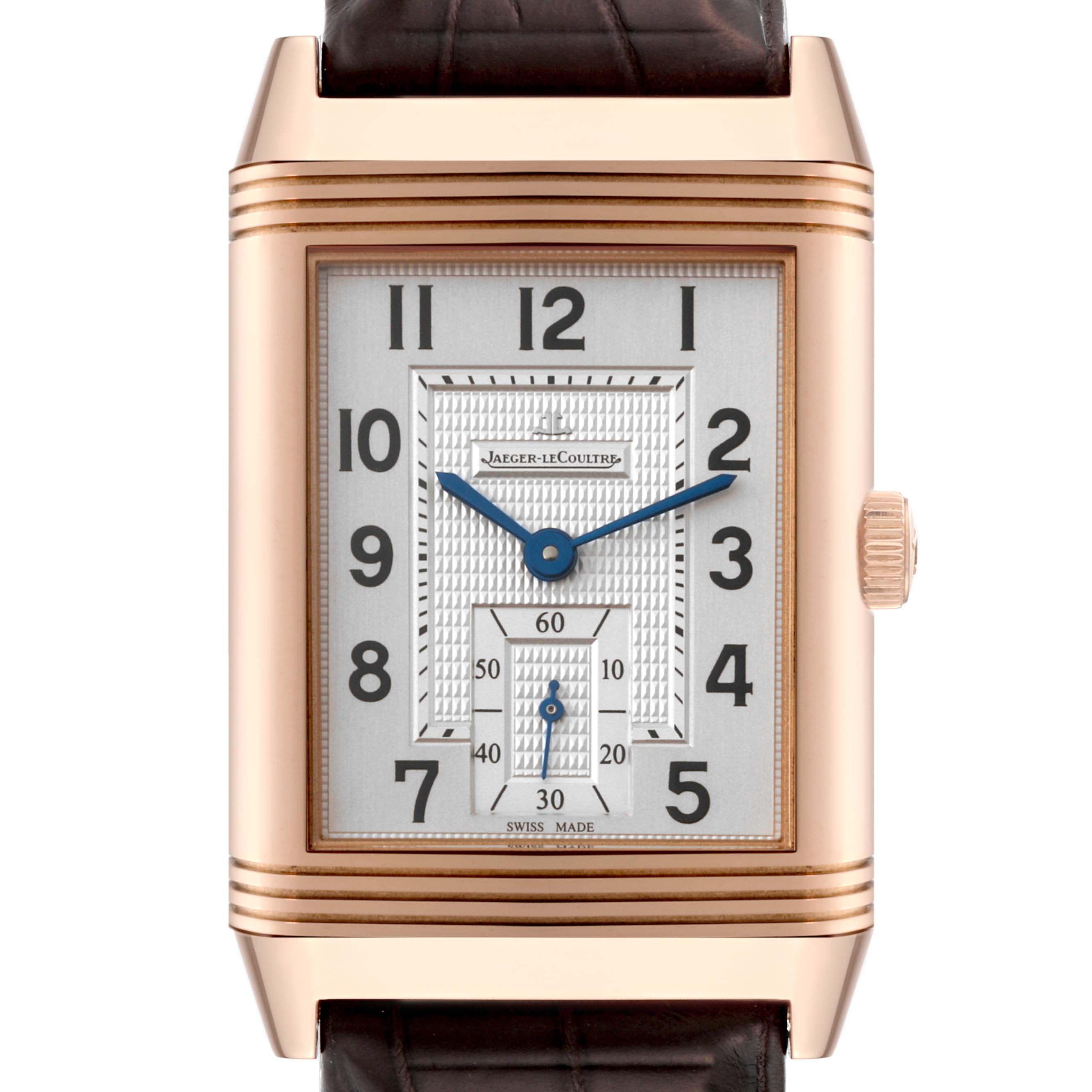 The image shows a front view of the Jaeger LeCoultre Reverso Q3732420 Men
s Rose Gold Silver Dial Q3732420 Men
s Rose Gold Silver Dial watch, highlighting its rectangular dial, blue hands, and rose gold case.