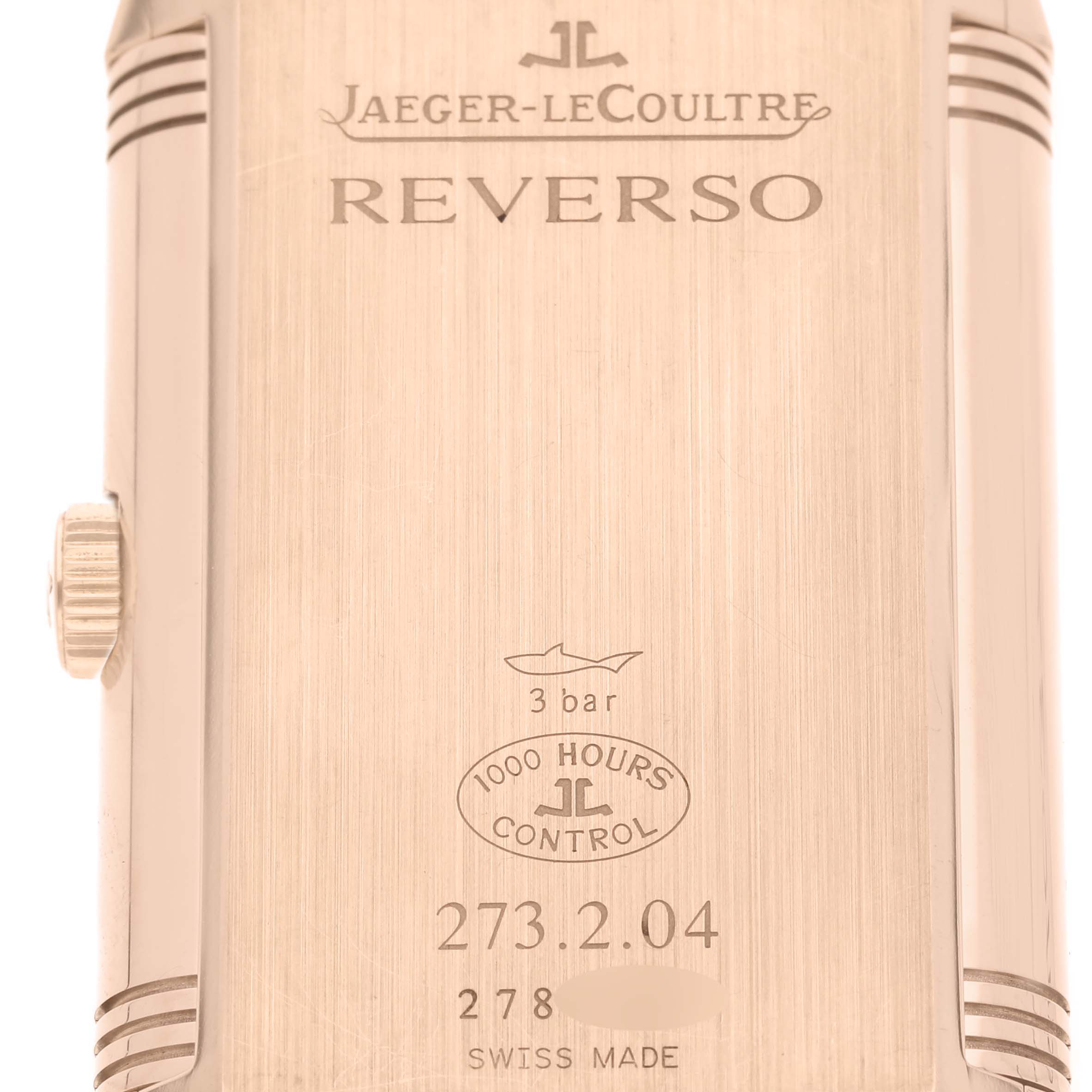 This image shows the back casing of a Jaeger-LeCoultre Reverso watch, including its crown and engraved details.