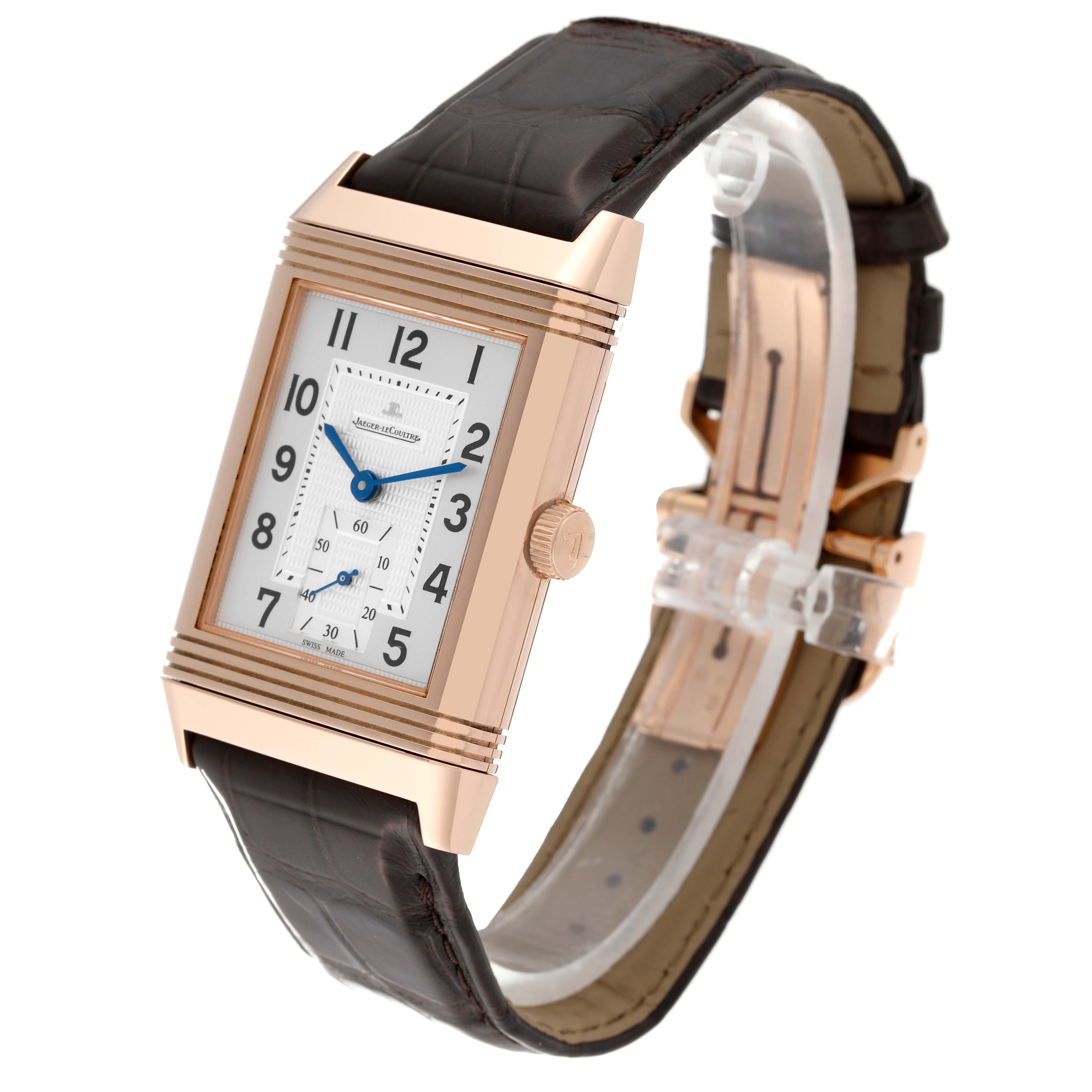 The image displays a Jaeger LeCoultre Reverso Q3732420 Men
s Rose Gold Silver Dial Q3732420 Men
s Rose Gold Silver Dial watch at an oblique angle, showing its face, crown, and leather strap.