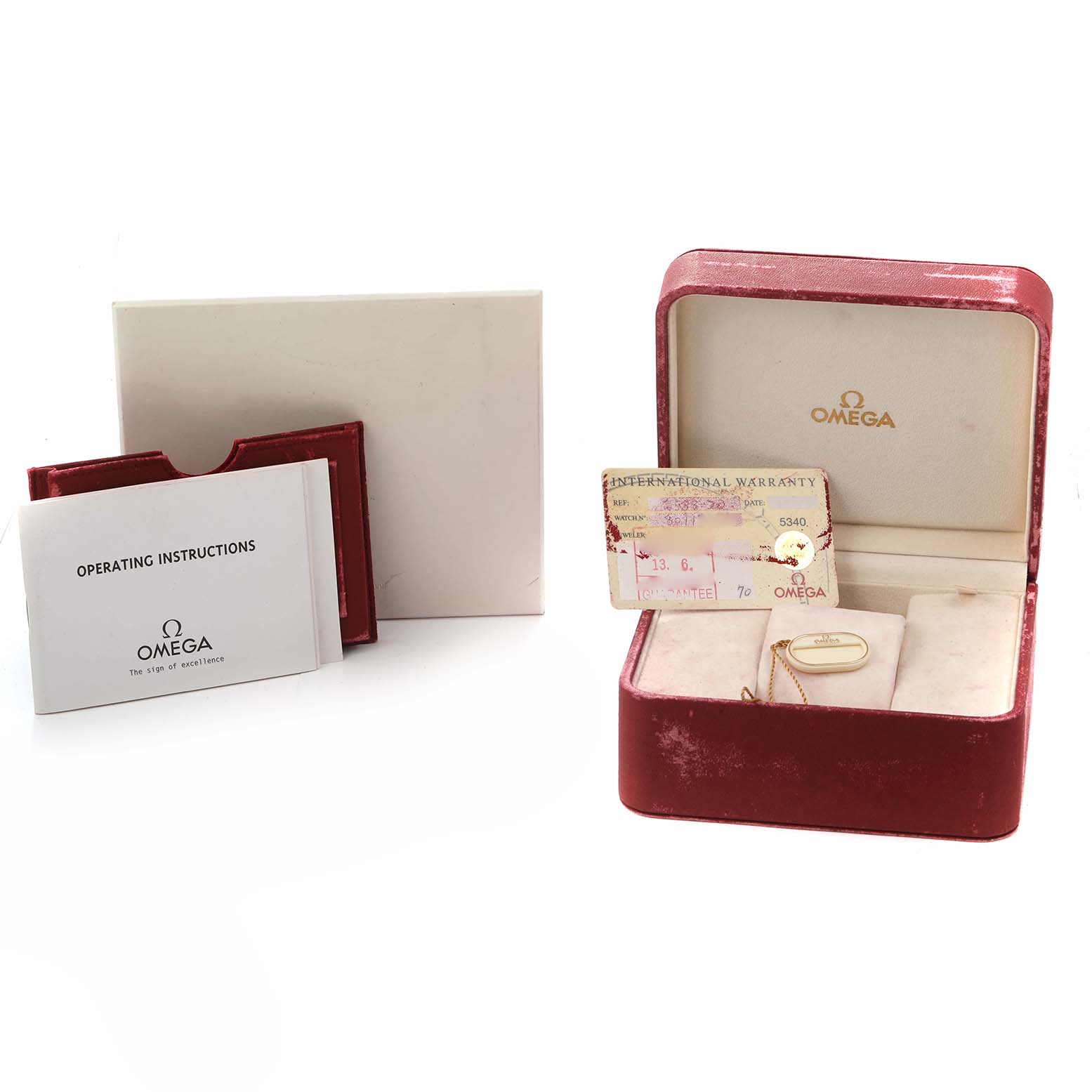 The image shows Omega Seamaster 2538.20.00 Men
s Stainless Steel White Dial accessories, including a warranty card, operating instructions, and a watch box, all viewed slightly from the side.