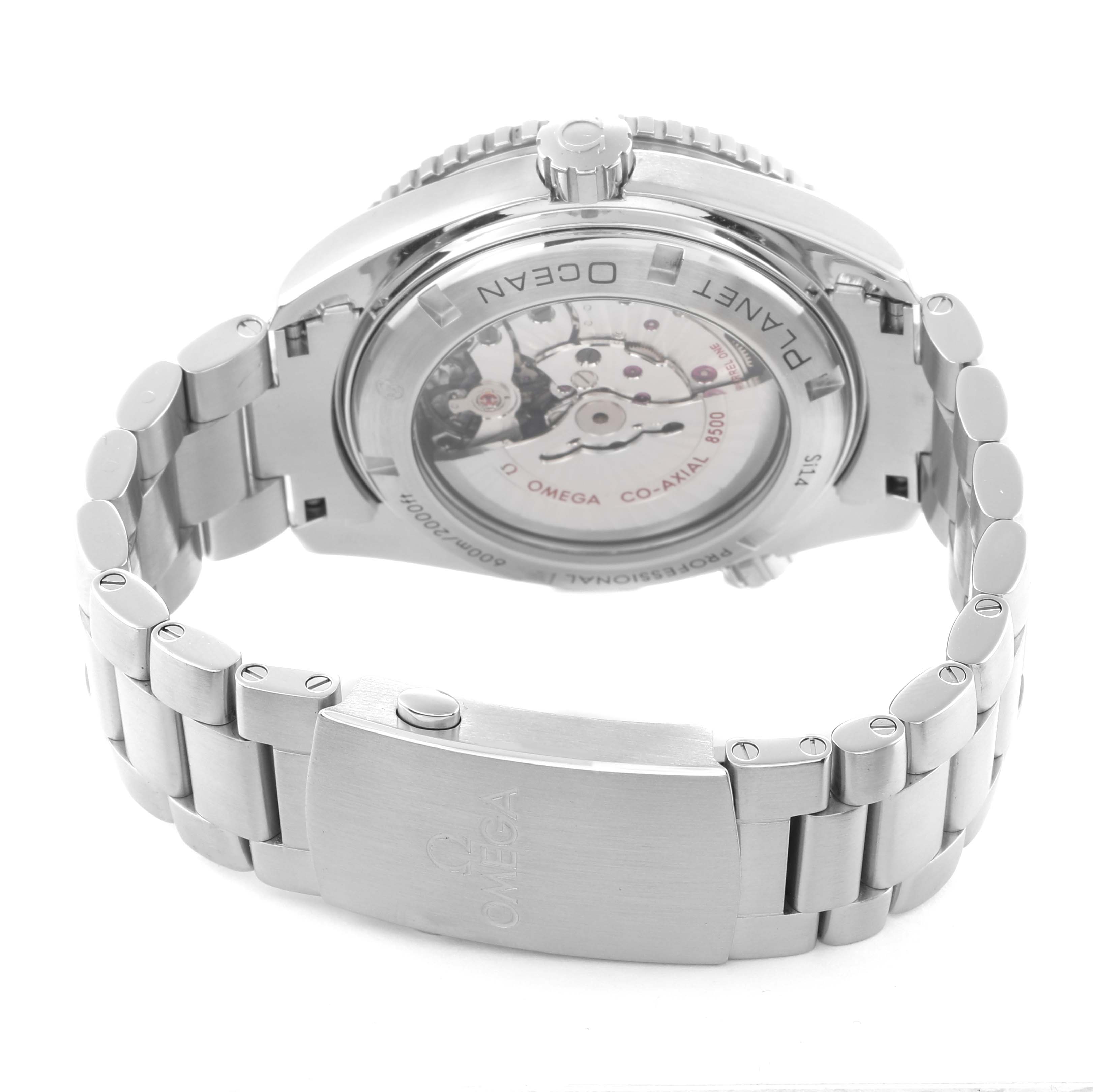 The image shows the back view of the Omega Planet Ocean 232.30.46.21.01.002 Men
s Stainless Steel Black Dial watch, highlighting its movement and the metal bracelet.