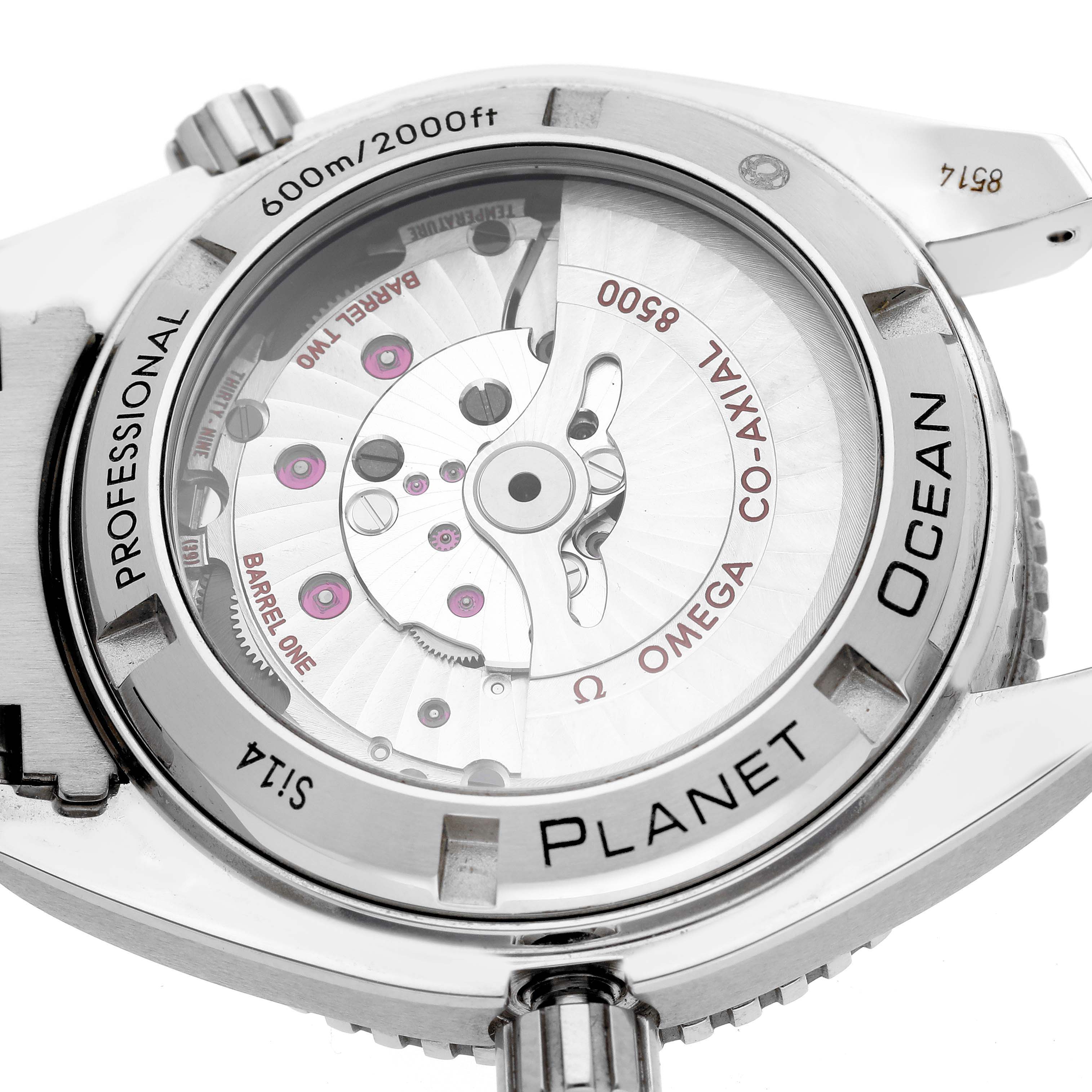 The image shows a close-up of the back case and movement of an Omega Planet Ocean 232.15.42.21.04.001 Men's Stainless Steel White Dial 232.15.42.21.04.001 Men's Stainless Steel White Dial watch, featuring its transparent case back and inner mechanisms.