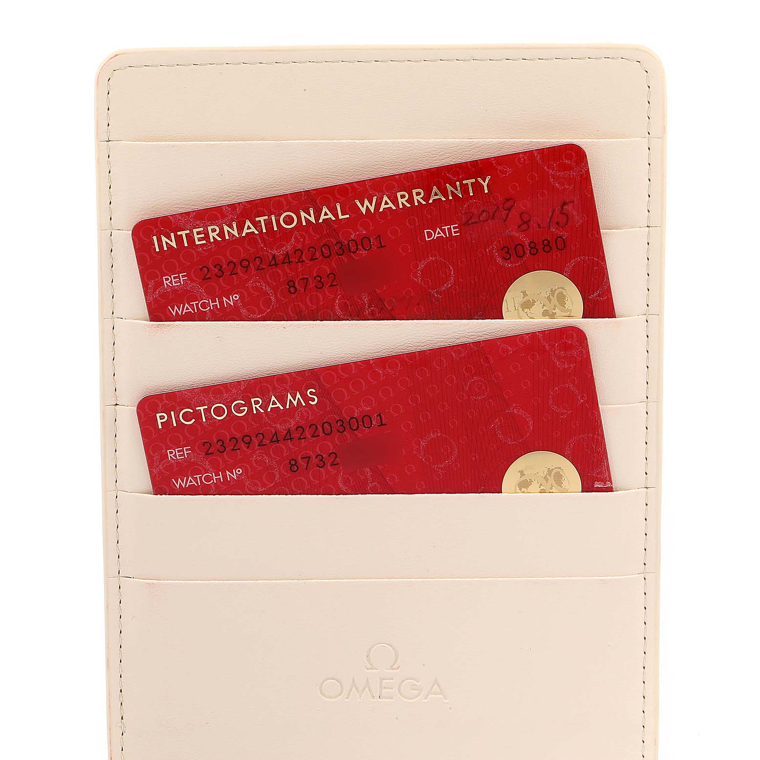 The image shows International Warranty and Pictograms cards in a holder for the Omega Planet Ocean 232.92.44.22.03.001 Men's Titanium Blue Dial 232.92.44.22.03.001 Men's Titanium Blue Dial watch model.