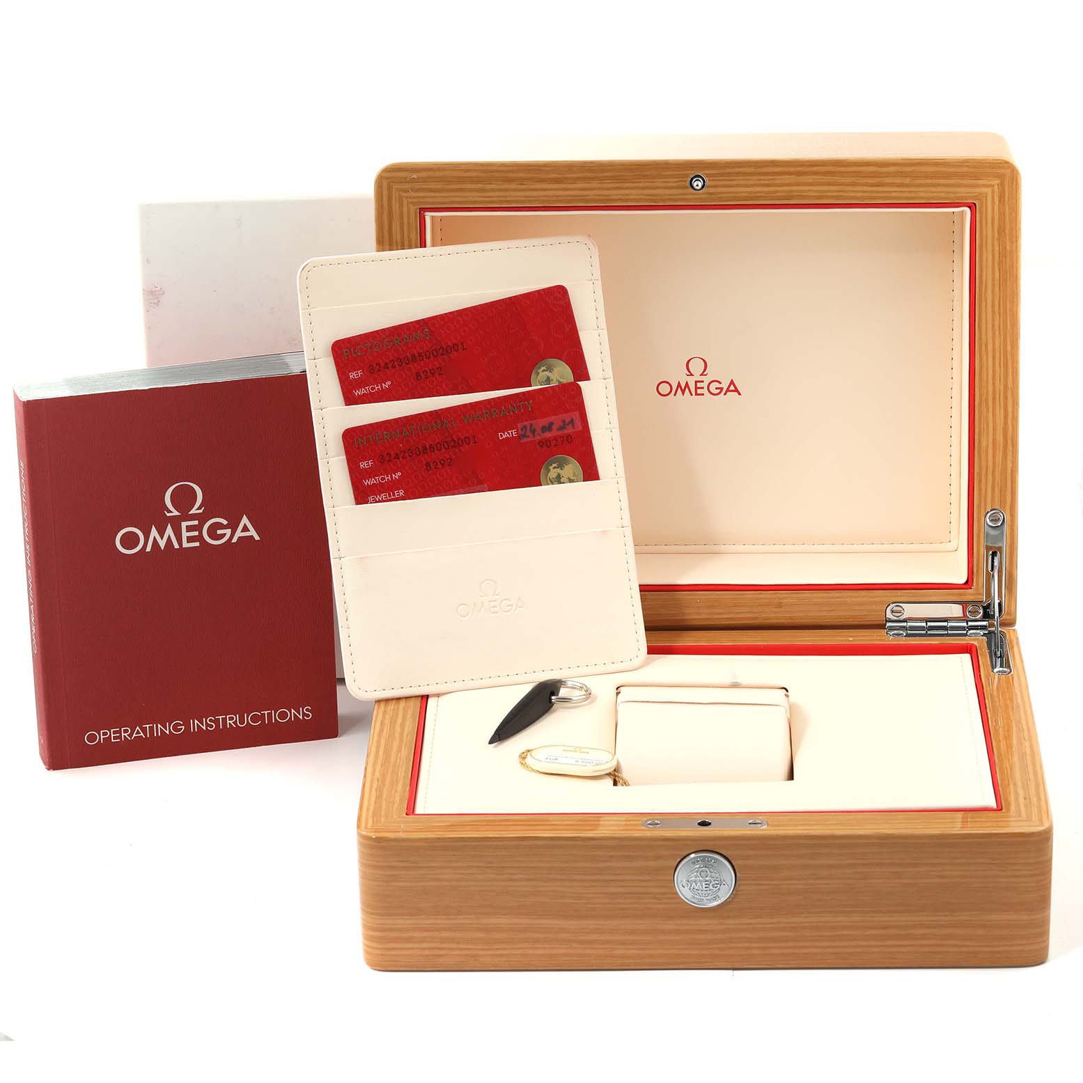 The image shows a straight-on view of the Omega Speedmaster 324.23.38.50.02.001 Men's Steel and Gold (two tone) Silver Dial 324.23.38.50.02.001 Men's Steel and Gold (two tone) Silver Dial watch accessories, including the box, instructions, and warranty cards.