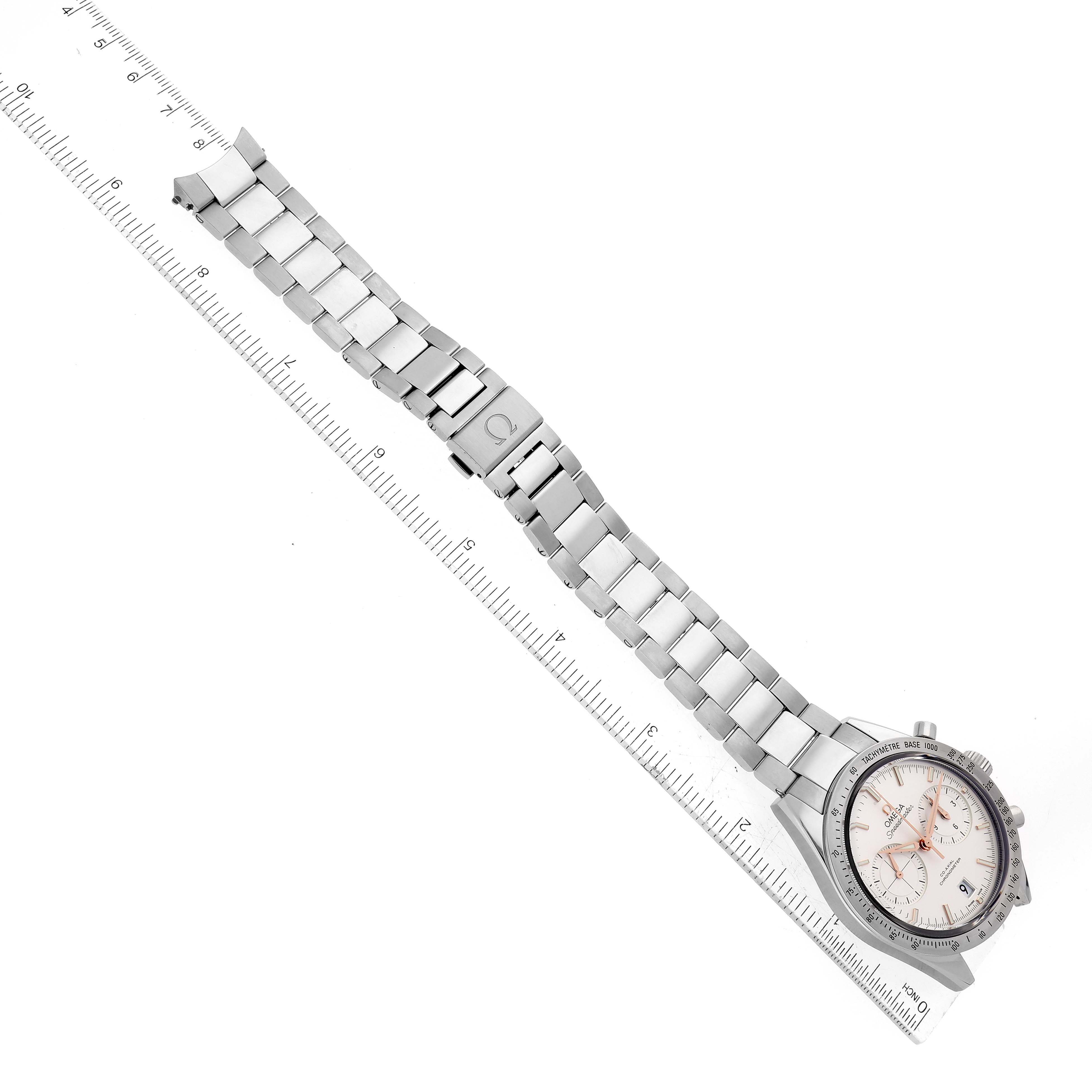 The image shows an Omega Speedmaster 331.10.42.51.02.002 Men's Stainless Steel Silver Dial 331.10.42.51.02.002 Men's Stainless Steel Silver Dial watch with its stainless steel bracelet laid alongside a ruler for measurement.