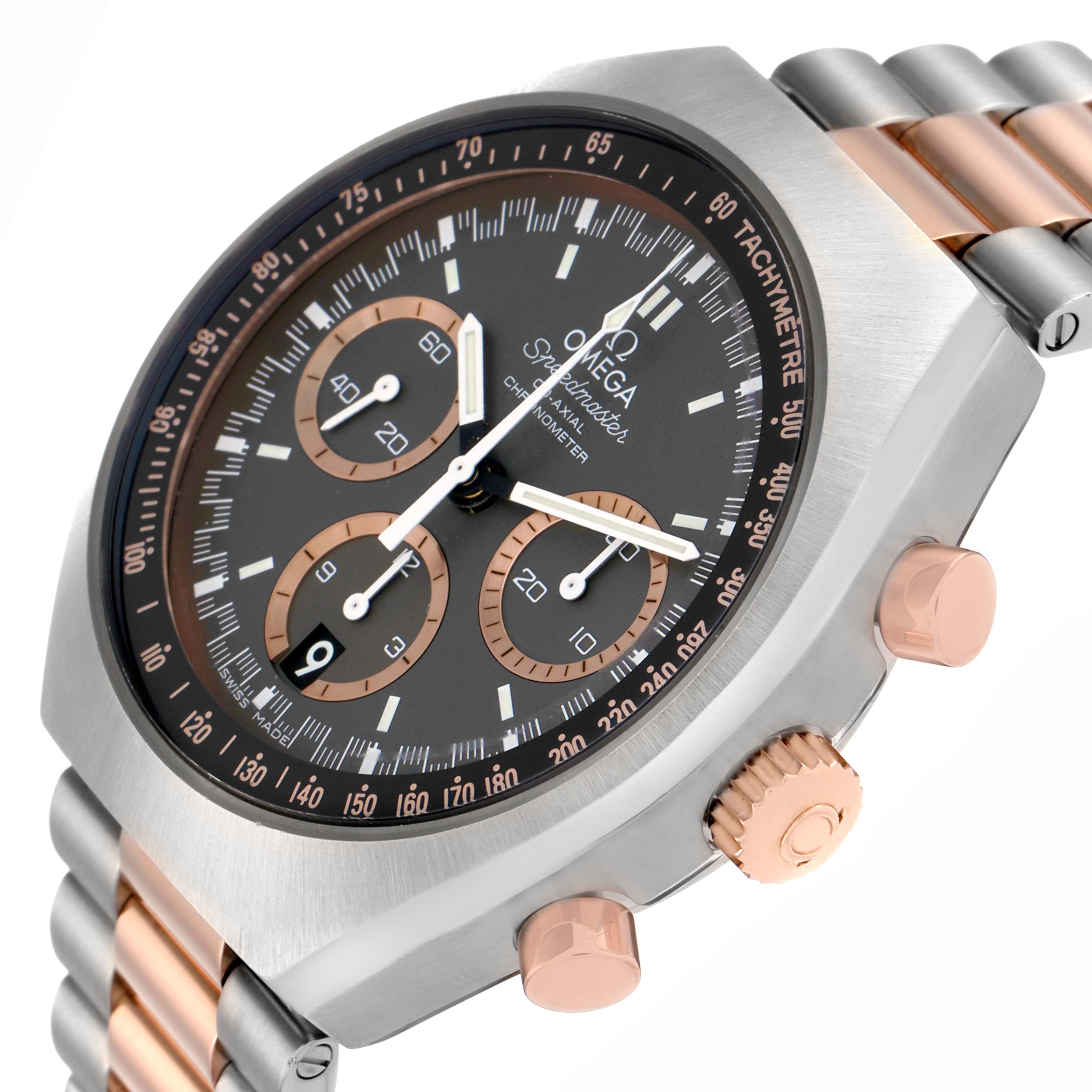 The Omega Speedmaster 327.20.43.50.01.001 Men
s Steel and Gold (two tone) Grey Dial watch is shown from an angled side view, highlighting the dial, bezel, crown, and chronograph pushers.