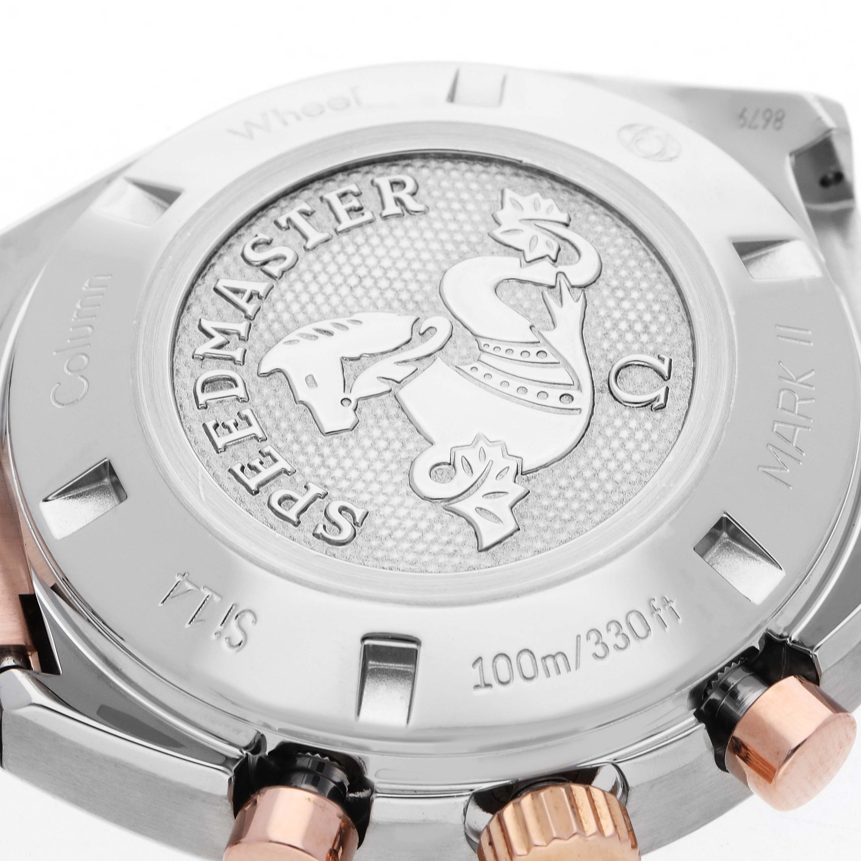 The image shows the case back of an Omega Speedmaster 327.20.43.50.01.001 Men
s Steel and Gold (two tone) Grey Dial, highlighting the embossed design and surrounding edge details.