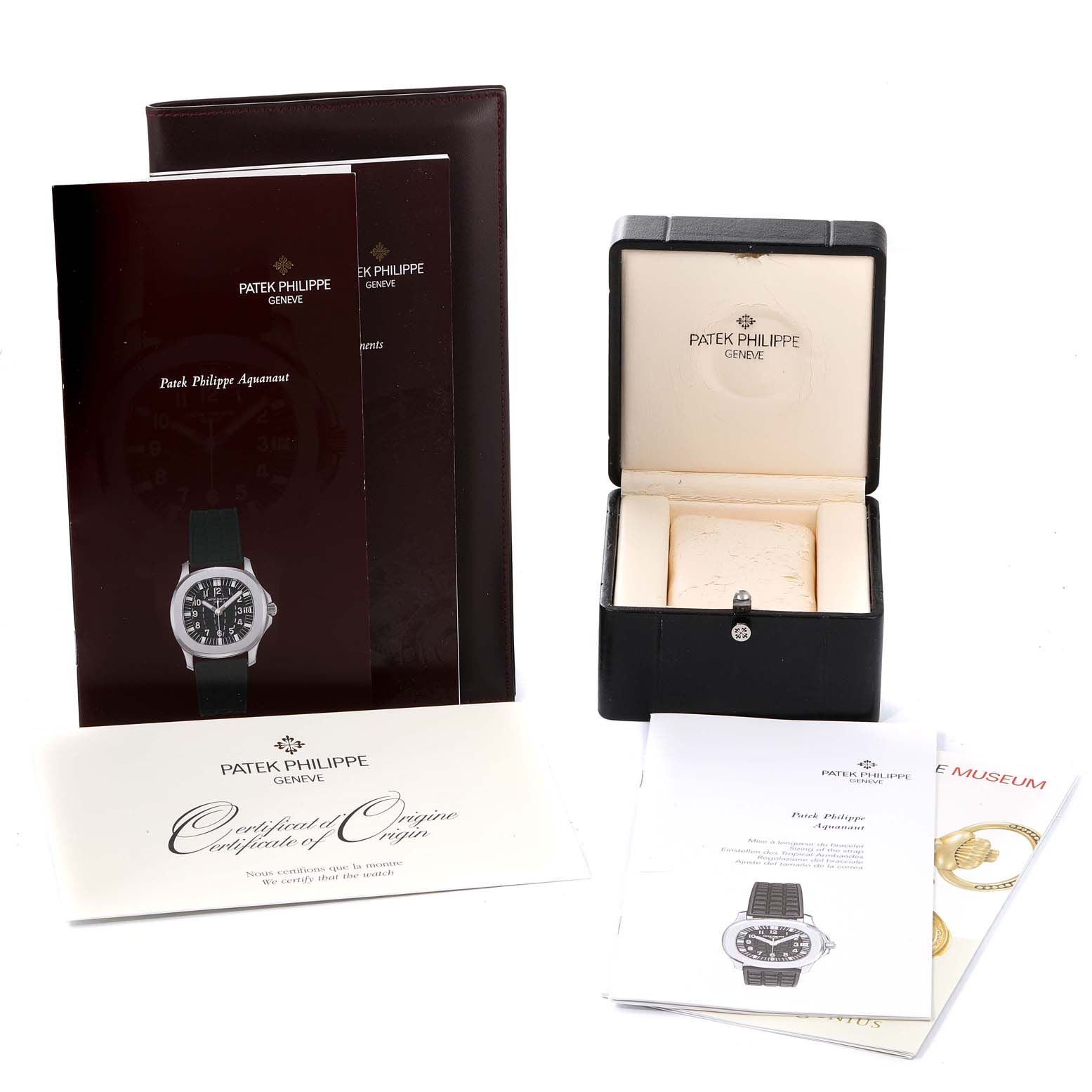 The image shows various accessories for the Patek Philippe Aquanaut 5065/1A-010 Men
s Stainless Steel Black Dial 5065/1A-010 Men
s Stainless Steel Black Dial watch, including booklets, a certificate, and a watch box.