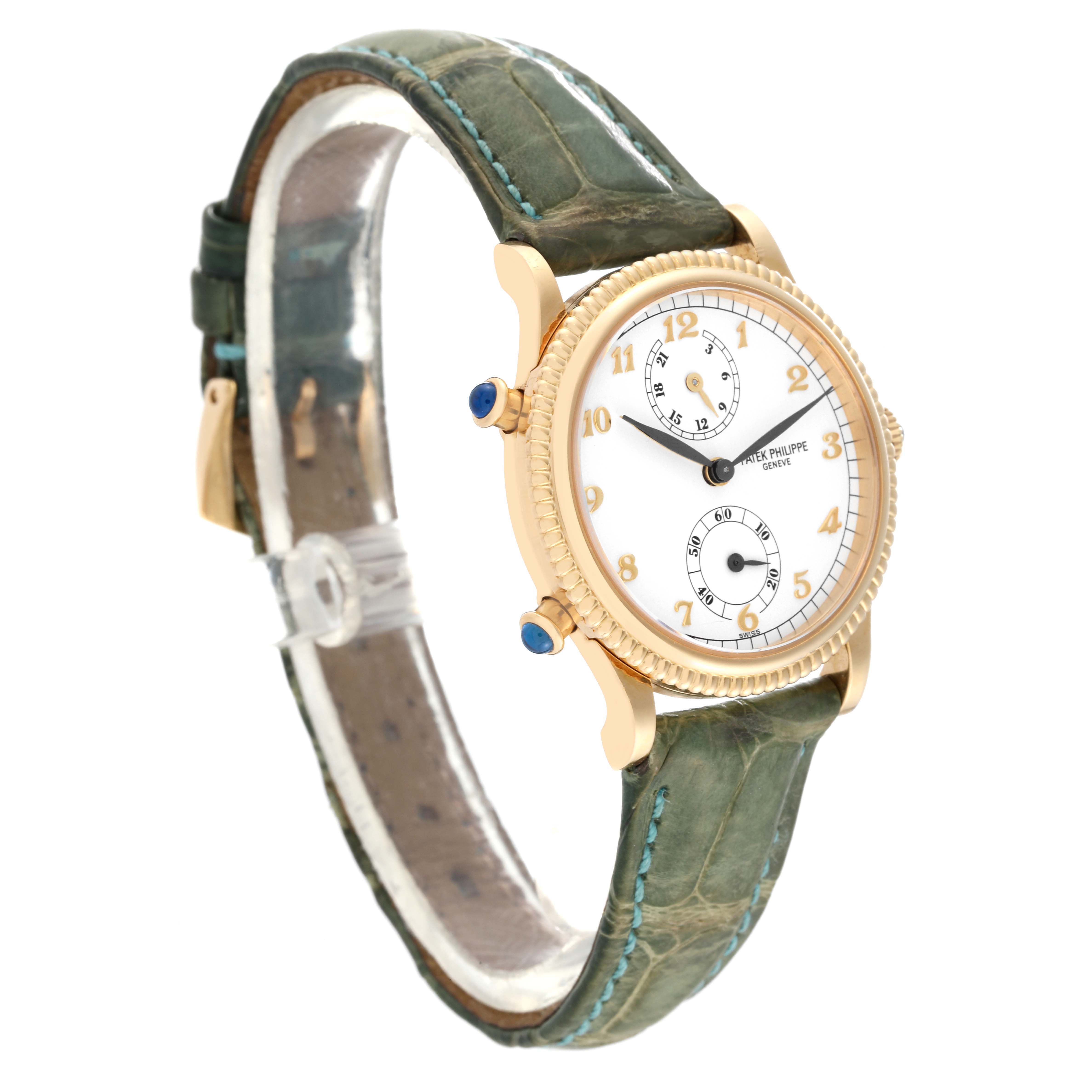 This Patek Philippe Calatrava 4864J-001 Women's Yellow Gold White Dial 4864J-001 Women's Yellow Gold White Dial watch is shown at a three-quarter angle, highlighting its case, dial, and green leather strap.