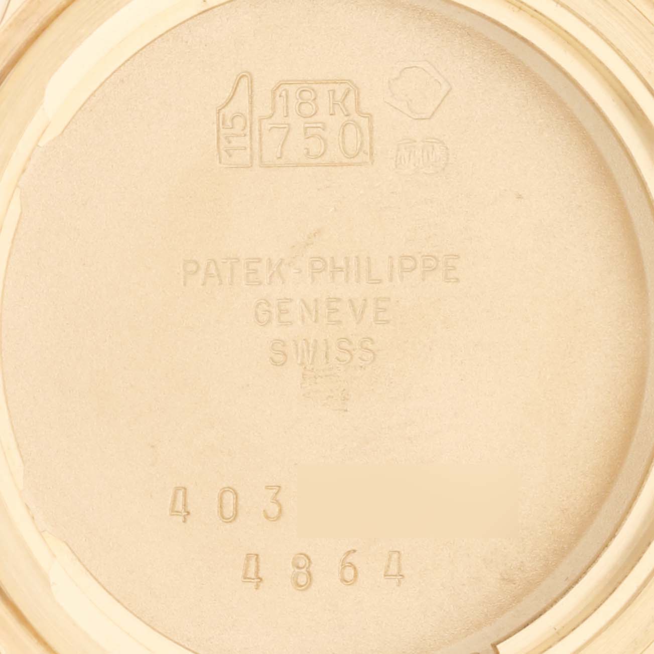 This image shows the inside of the case back of a Patek Philippe Calatrava 4864J-001 Women's Yellow Gold White Dial 4864J-001 Women's Yellow Gold White Dial model, highlighting markings such as "18K 750" and the brand's engraving.