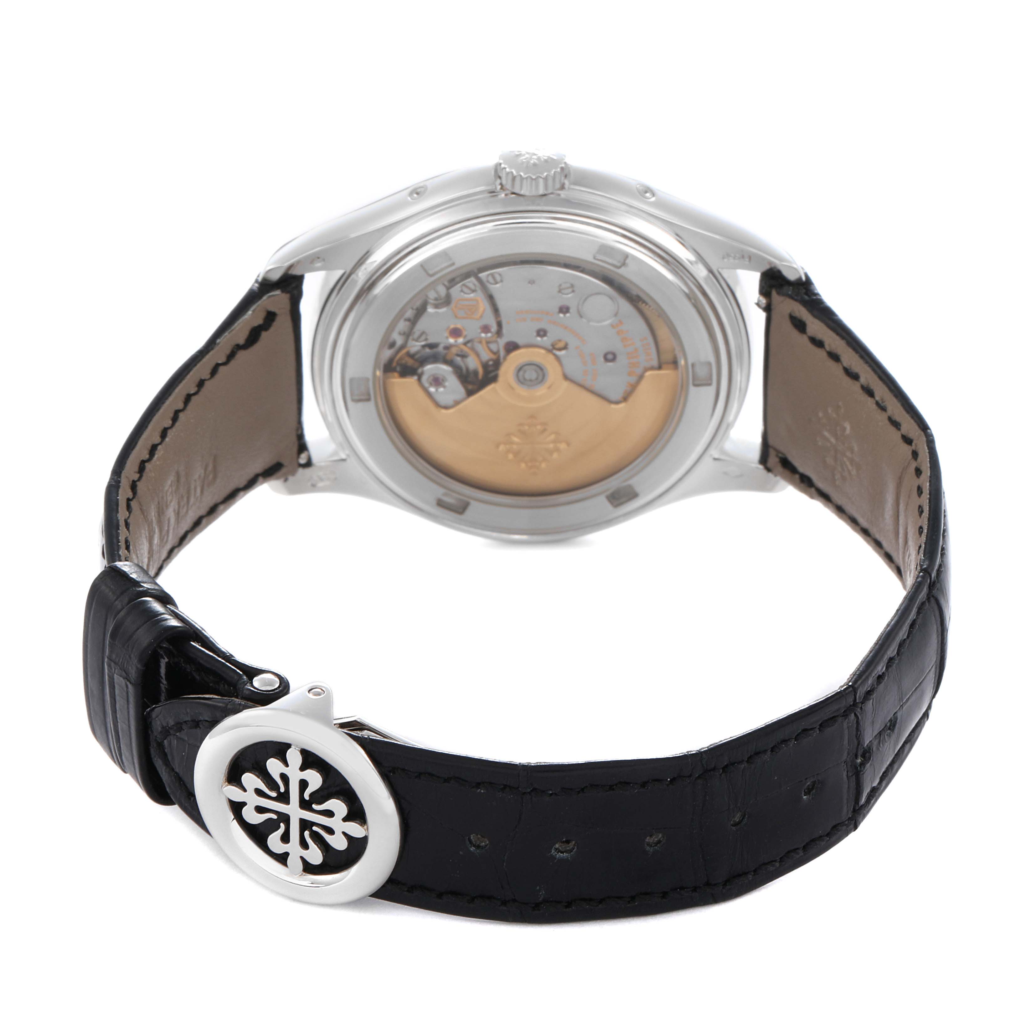 The image shows the back of the Patek Philippe Complications 5146P-001 Men's White Gold Grey Dial watch, highlighting the exhibition case back and leather strap with a clasp.