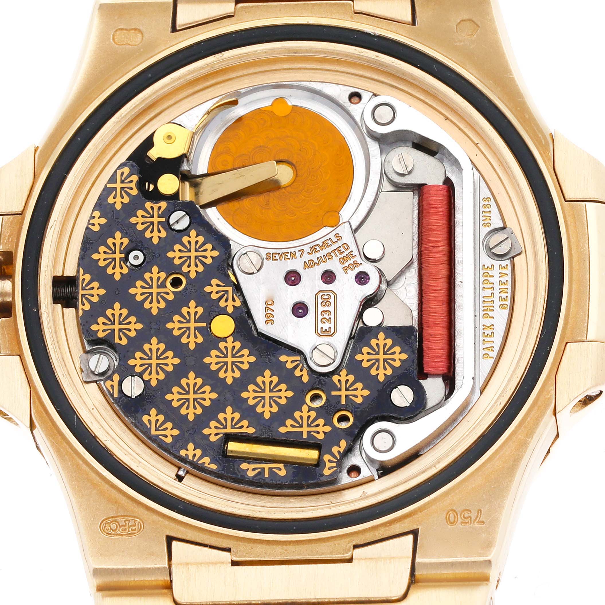 This image shows the intricate back mechanism of a Nautilus model by Patek Philippe, including the gears, jewels, and decorative engravings.