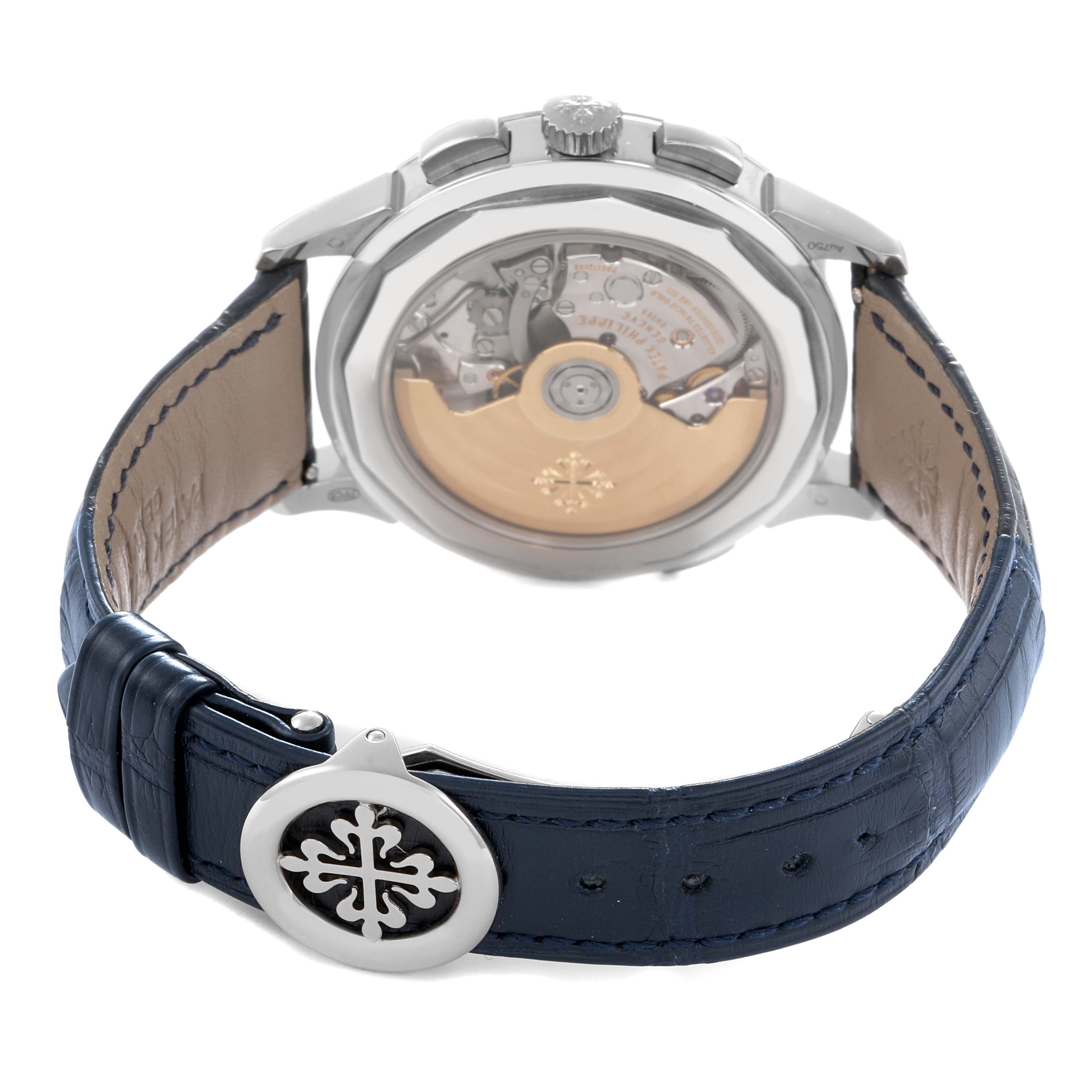 The Patek Philippe Complications 5930G-001 Men
s White Gold Blue Dial watch is shown from the back, highlighting the movement and leather strap with logo clasp.