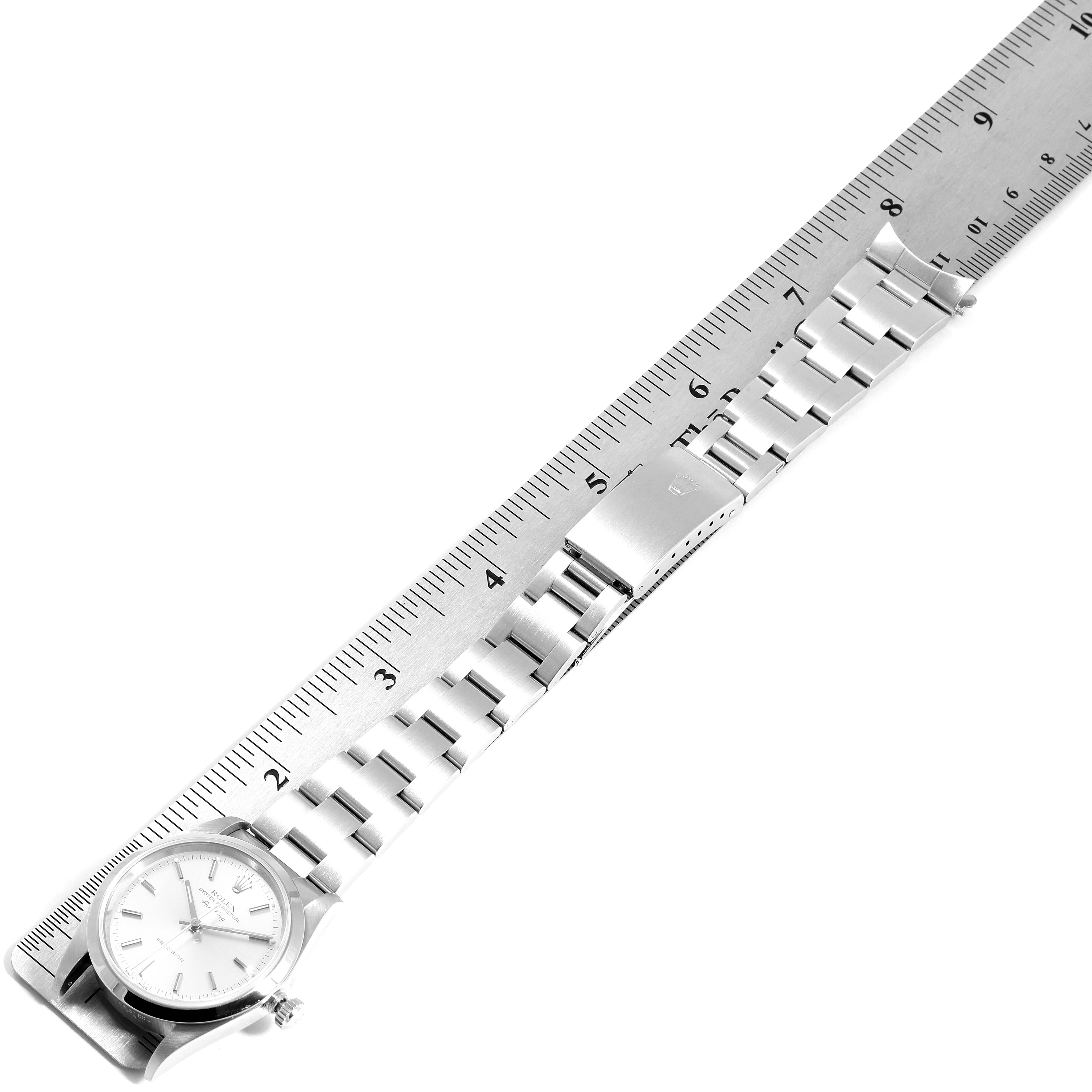 The image shows the Rolex Air-King 14000 Men's Stainless Steel Silver Dial 14000 Men's Stainless Steel Silver Dial watch laid flat with its bracelet extended along a ruler for measurement.
