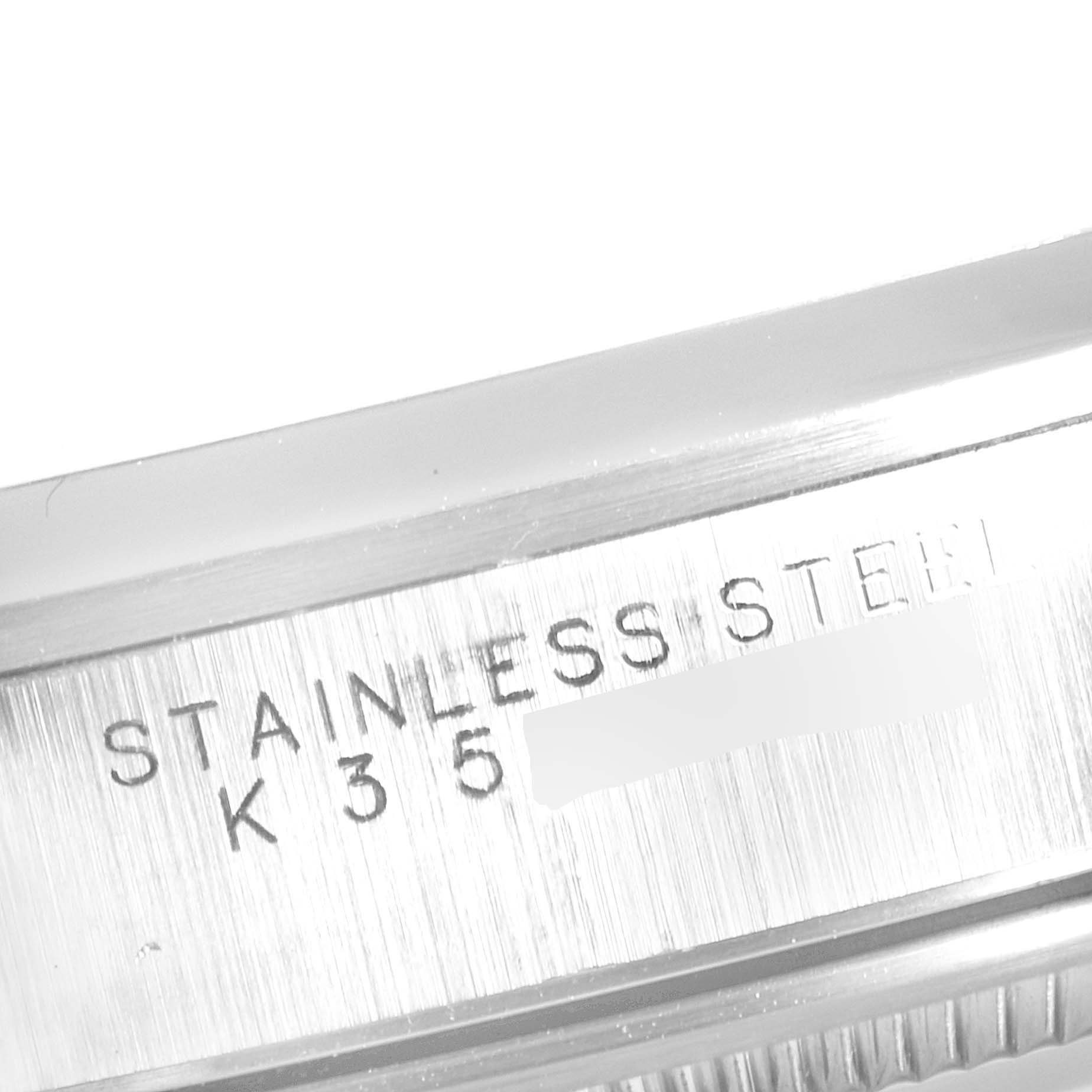 The image shows a close-up of the stainless steel casing of a Rolex Air-King 14000 Men's Stainless Steel Silver Dial 14000 Men's Stainless Steel Silver Dial watch, highlighting its engravings.