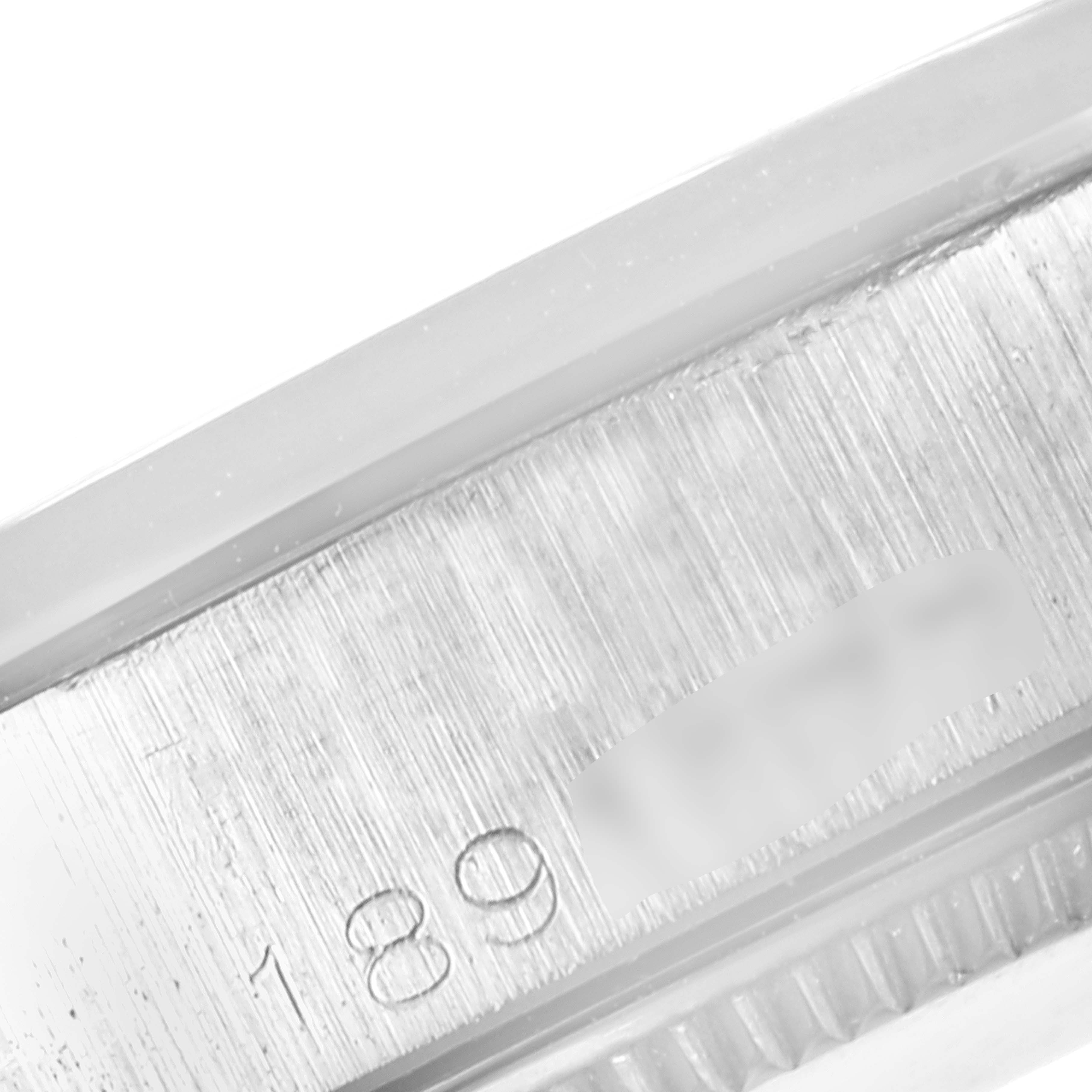 This image shows a close-up of the case side with a partial serial number engraving on the Vintage Collection model by Rolex.