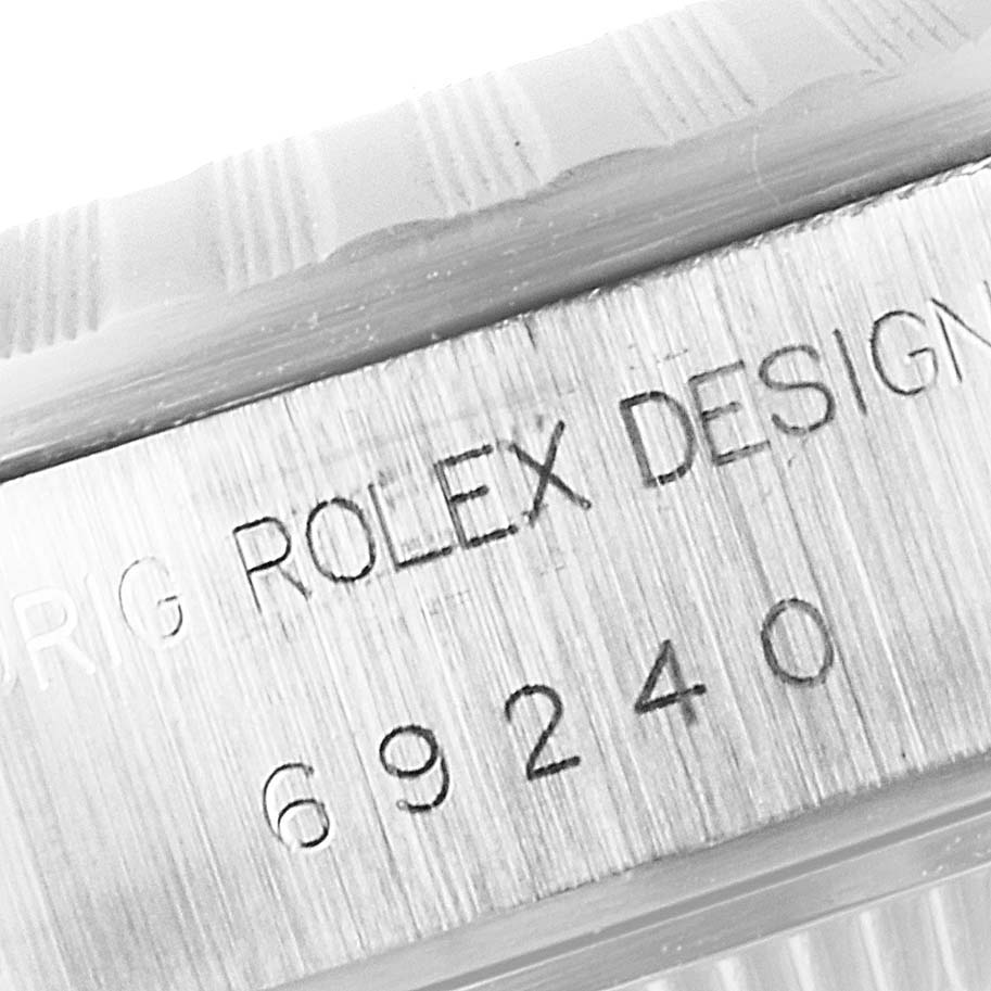 This image shows a close-up of the case side of a Rolex Date 69240 Women's Stainless Steel Black Dial 69240 Women's Stainless Steel Black Dial model, displaying the model number and "Rolex Design" engraving.