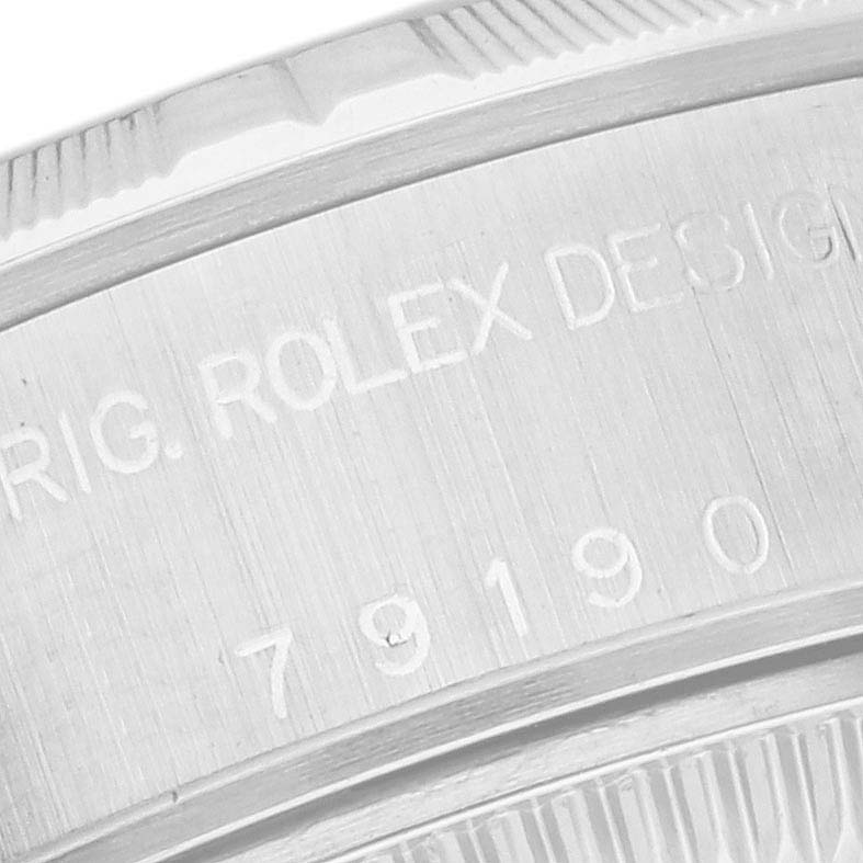 The image shows a close-up of the engraved case back of the Rolex Date 79190 Women's Stainless Steel Pink Dial 79190 Women's Stainless Steel Pink Dial model watch.
