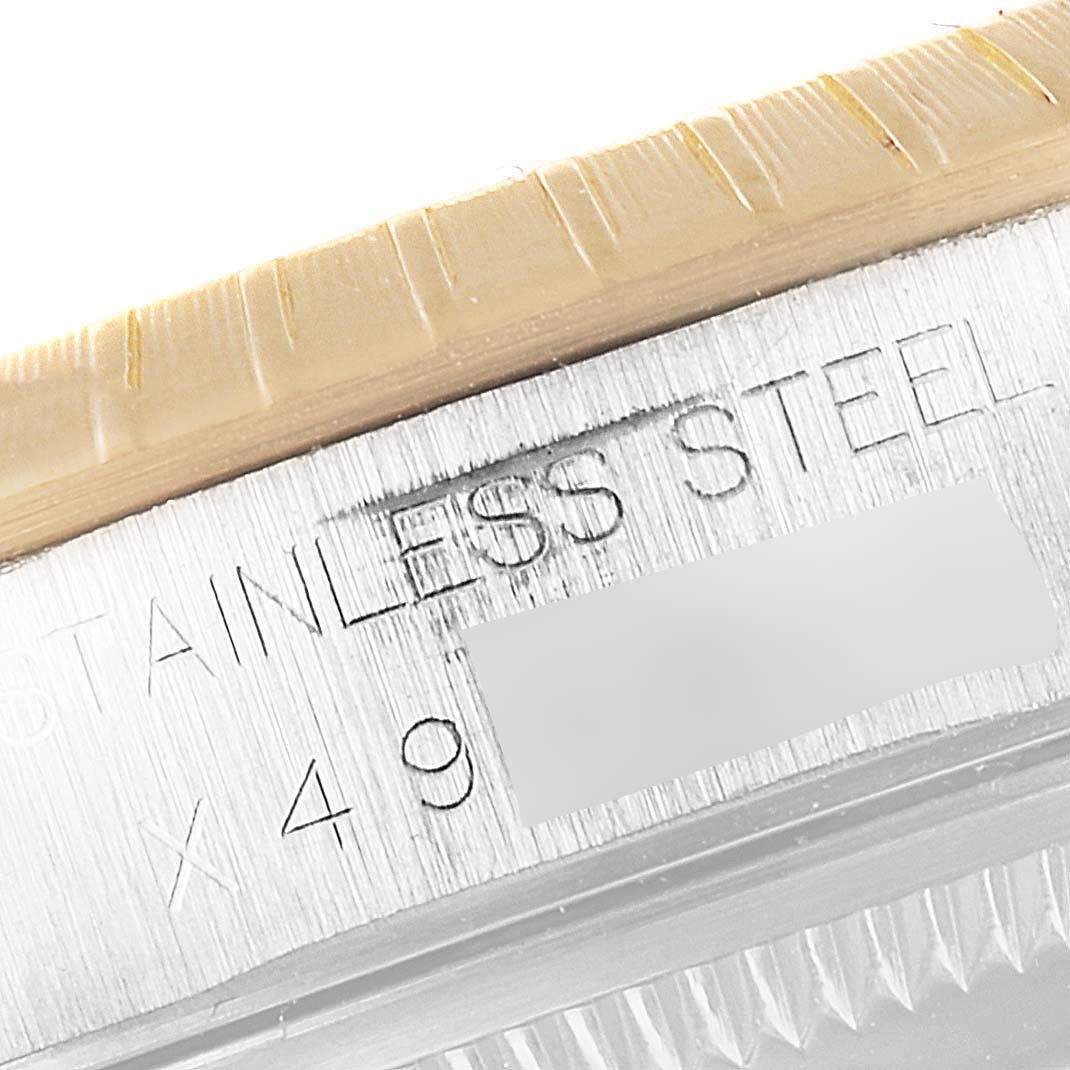 This image shows a close-up of the Rolex Date 15223 Men's Steel and Gold (two tone) Silver Dial 15223 Men's Steel and Gold (two tone) Silver Dial model's stainless steel case and part of the bezel.