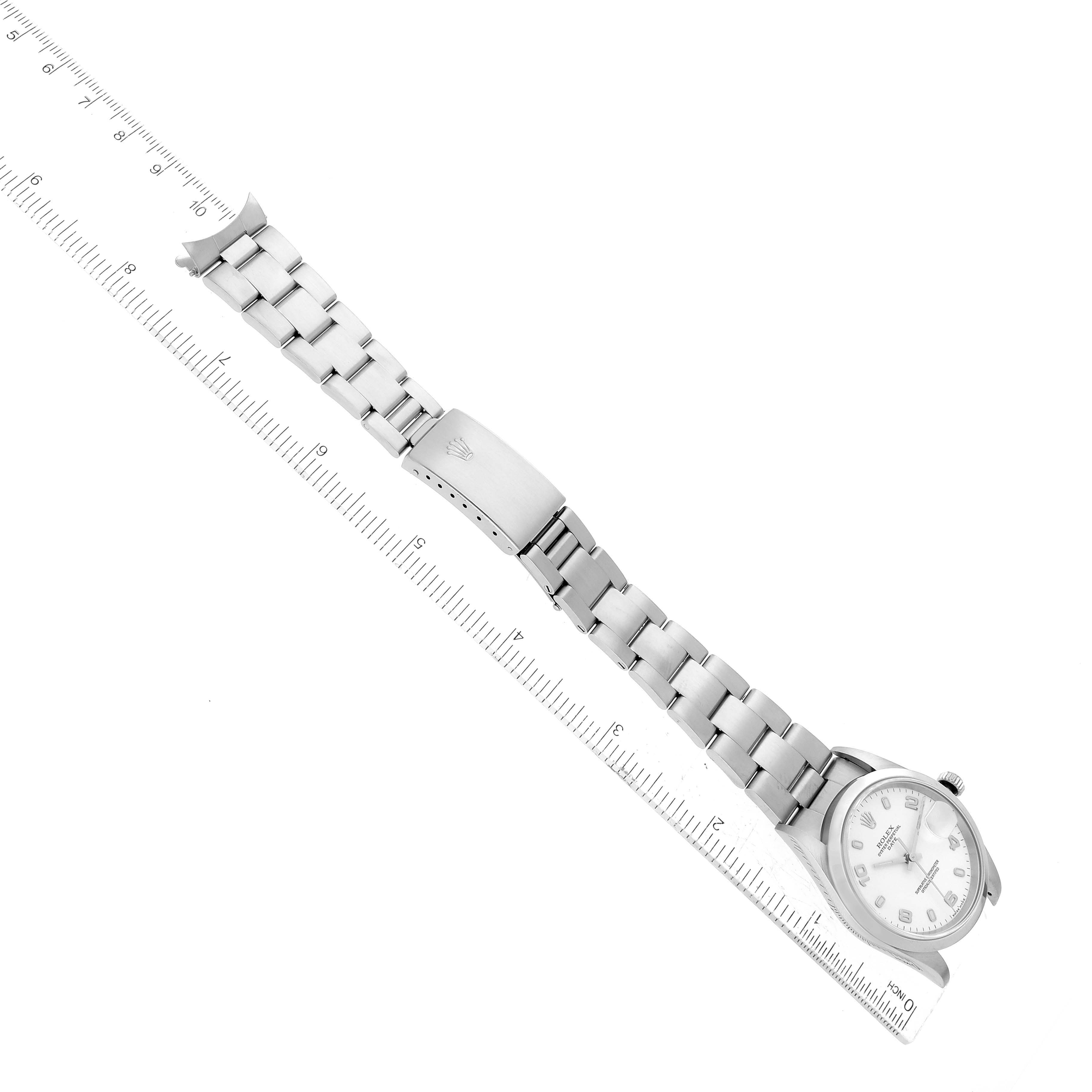 The image shows a top view of a Rolex Date 15200 Men's Stainless Steel White Dial 15200 Men's Stainless Steel White Dial model, displaying the watch face, bracelet, and clasp, alongside a ruler for scale.