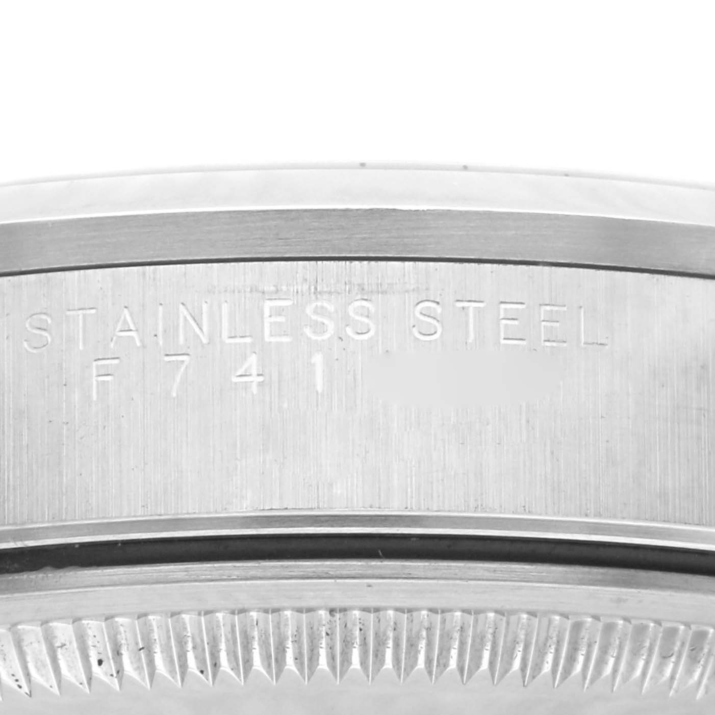 The image shows a close-up of the case side of a Rolex Date 15200 Men's Stainless Steel White Dial 15200 Men's Stainless Steel White Dial model, highlighting the stainless steel engraving and serial number.