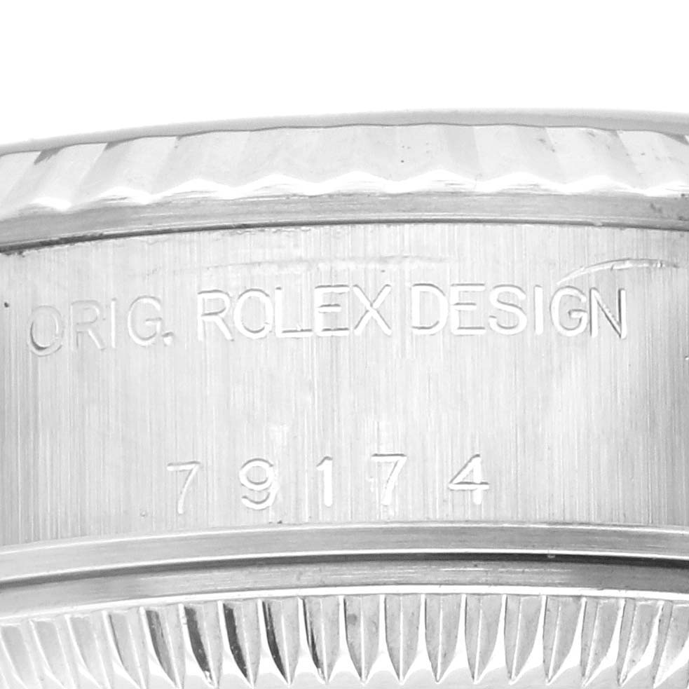 This image shows a close-up of the engravings on the side of the bezel and mid-case of a Rolex Datejust 79174 Women's Stainless Steel Silver Dial 79174 Women's Stainless Steel Silver Dial model watch.