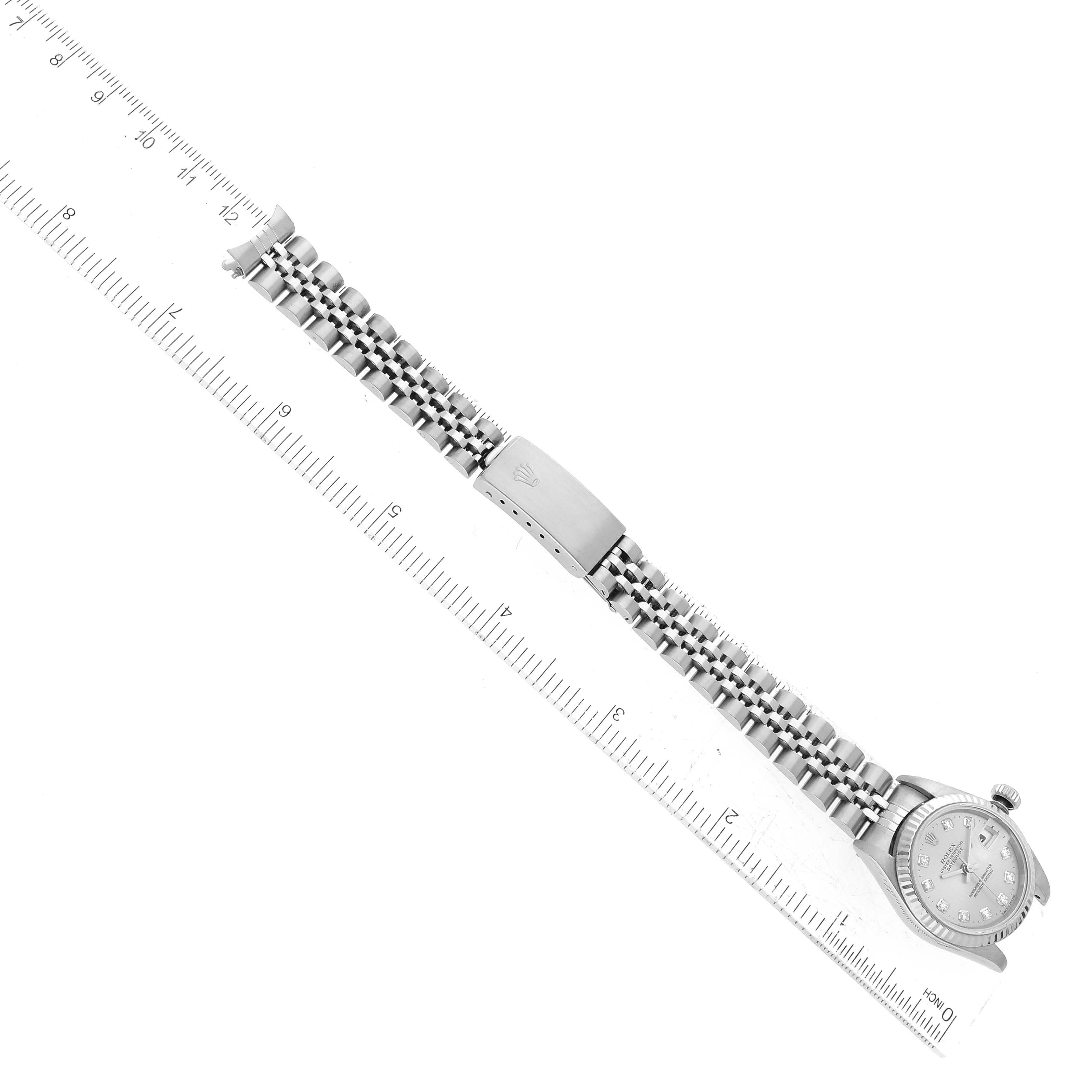 The image shows a top-down view of a Rolex Datejust 79174 Women's Stainless Steel Silver Dial 79174 Women's Stainless Steel Silver Dial watch lying flat against a ruler, displaying its bracelet and clasp.