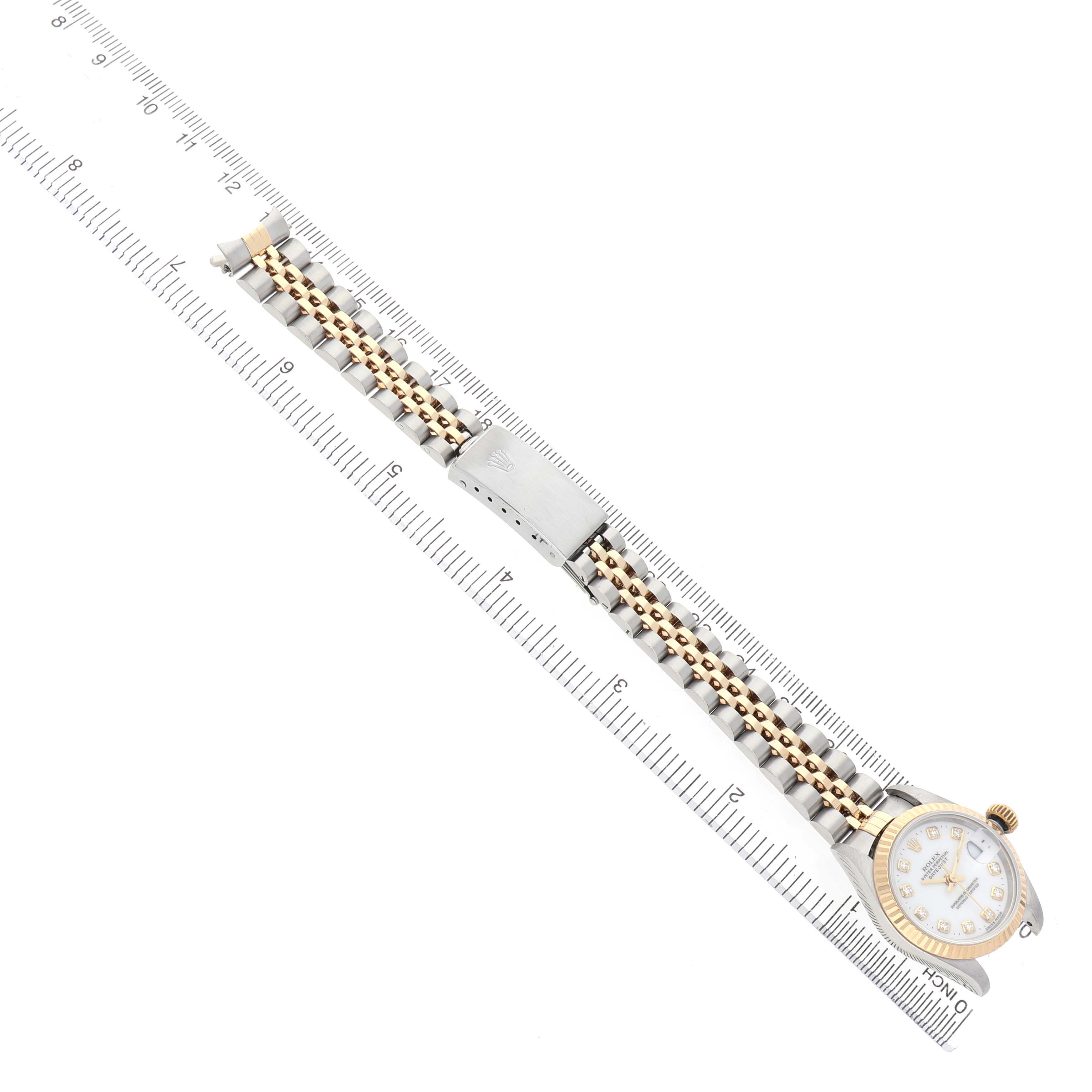 The image shows a Rolex Datejust 79173 Women's Stainless Steel White Dial watch laying flat, with ruler measurements and highlighting the gold and silver bracelet and face.