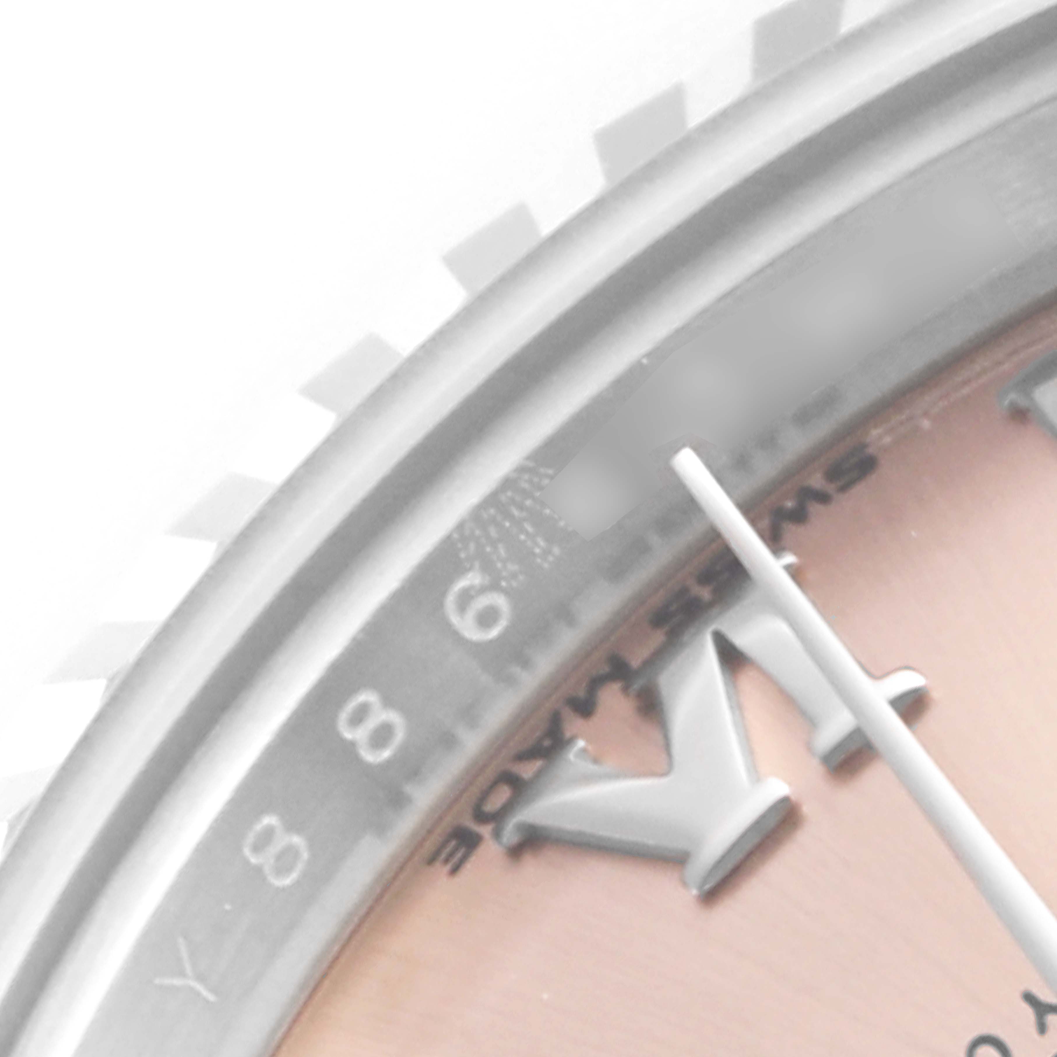The close-up image of the Rolex Datejust 279174 Women's Stainless Steel Pink Dial 279174 Women's Stainless Steel Pink Dial watch shows part of the dial, hour markers, and the fluted bezel at an angled view.