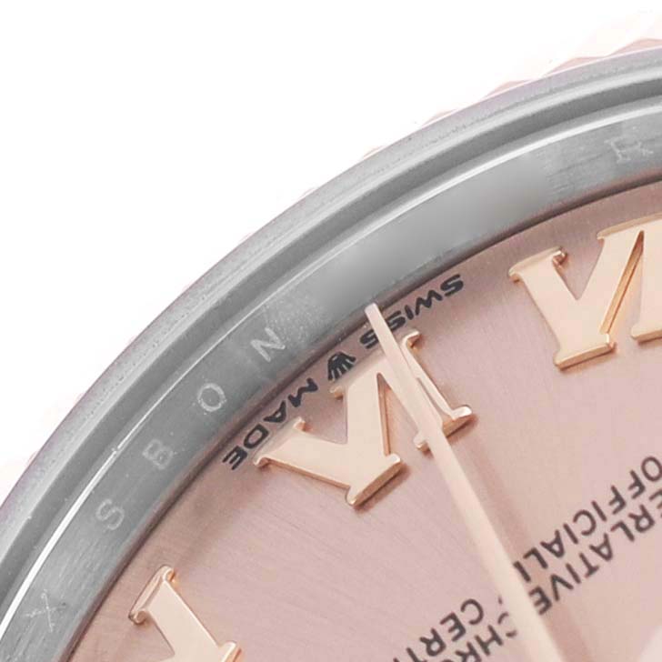 The image shows a close-up of the dial and bezel of a Rolex Mid-Size 278271 Women's Steel and Gold (two tone) Pink Dial watch, highlighting the Roman numeral markers and "Swiss Made" text.