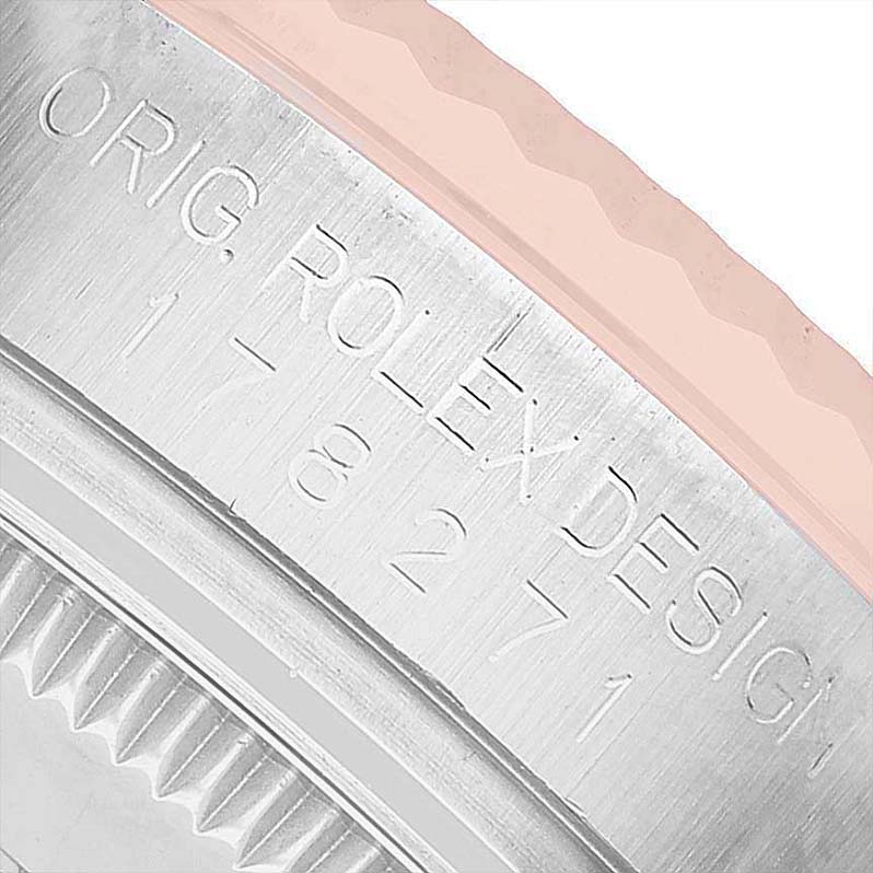 The image shows a close-up of the Rolex Mid-Size 178271 Women's Steel and Gold (two tone) White Dial model's case side, highlighting the "ROLEX DESIGN" engraving.
