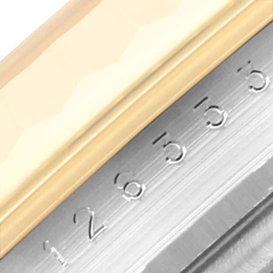 The image shows a close-up of the bezel and part of the dial of a Rolex Datejust 41 126333 Men's Steel and Gold (two tone) Champagne Dial 126333 Men's Steel and Gold (two tone) Champagne Dial watch.