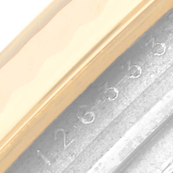 The image shows a close-up of the engraved serial number and gold bezel of the Rolex Datejust 41 126333 Men's Steel and Gold (two tone) Black Dial 126333 Men's Steel and Gold (two tone) Black Dial watch.