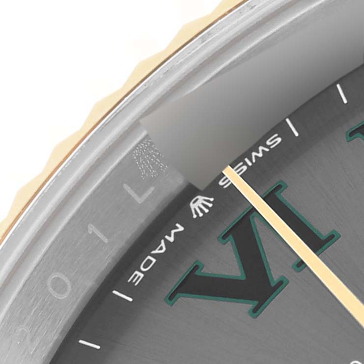 This image shows a magnified view of the dial and bezel of a Rolex Datejust 41 126333 Men's Steel and Gold (two tone) Grey Dial 126333 Men's Steel and Gold (two tone) Grey Dial, highlighting the "Swiss Made" text and part of the hour marker.