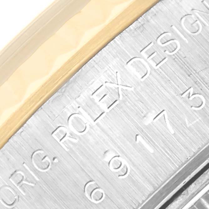 This close-up image shows the engraved details on the side of a Rolex Datejust 69173 Women's Steel and Gold (two tone) Champagne Dial 69173 Women's Steel and Gold (two tone) Champagne Dial watch case.