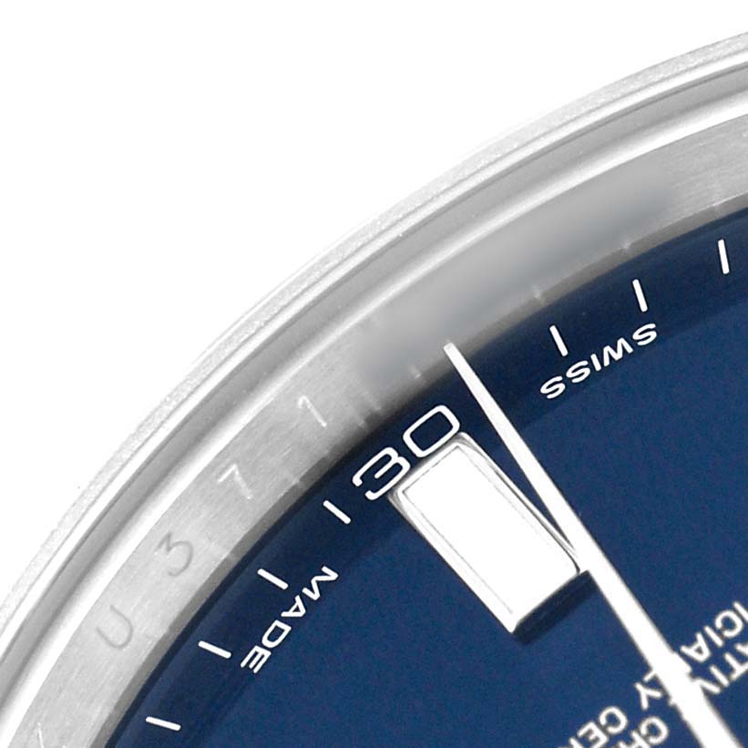 The image shows a partial view of the Rolex Datejust 41 116334 Men's Stainless Steel Blue Dial's blue dial, focusing on the date window and indices.