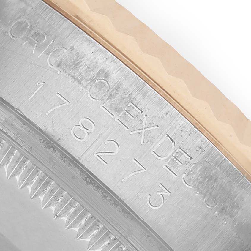 The image shows a close-up of the case edge and serial engraving on a Rolex Mid-Size 178273 Women's Steel and Gold (two tone) Silver Dial watch.