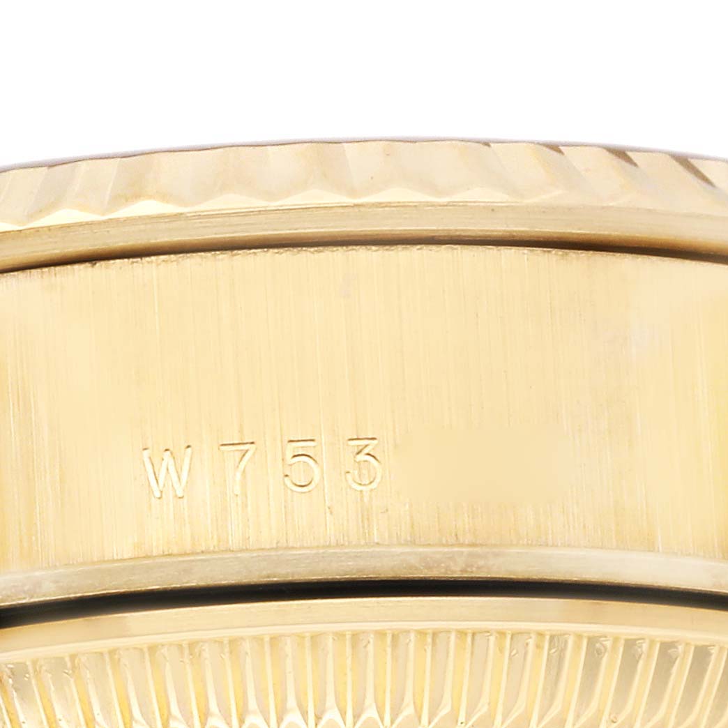This close-up image shows the side of the bezel of a Rolex President 69178 Women's Yellow Gold Champagne Dial 69178 Women's Yellow Gold Champagne Dial model, highlighting engraved markings.