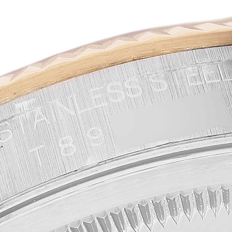 This image shows a close-up of the bezel and case edge of a Rolex Datejust 16233 Men's Steel and Gold (two tone) Black Dial 16233 Men's Steel and Gold (two tone) Black Dial watch, highlighting the stainless steel and some text.