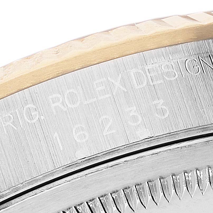 This close-up image shows the model engraving and part of the bezel on a Rolex Datejust 16233 Men's Steel and Gold (two tone) Black Dial 16233 Men's Steel and Gold (two tone) Black Dial watch.