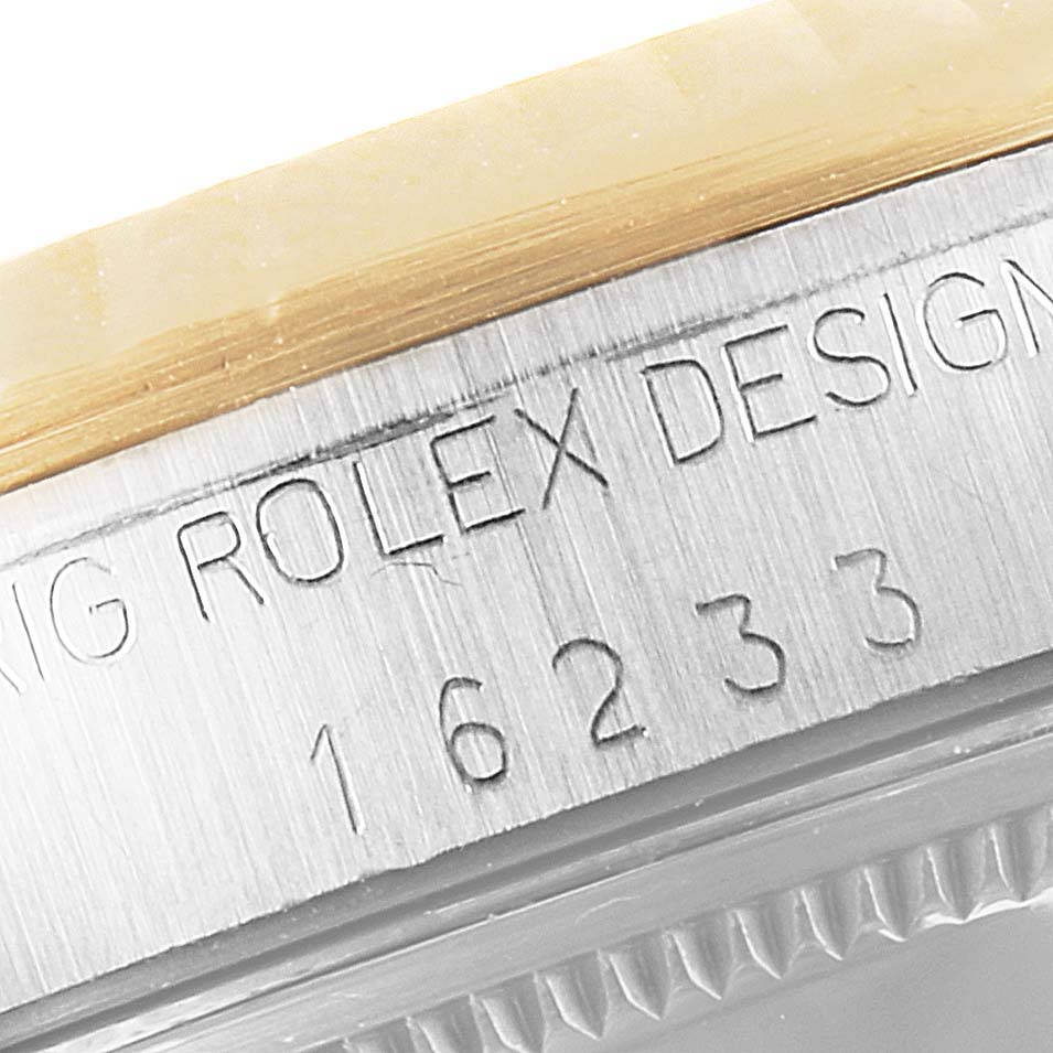 This image shows a close-up of the serial number and "Rolex Design" inscription on the case of a Rolex Datejust 16233 Men's Steel and Gold (two tone) Champagne Dial 16233 Men's Steel and Gold (two tone) Champagne Dial watch.