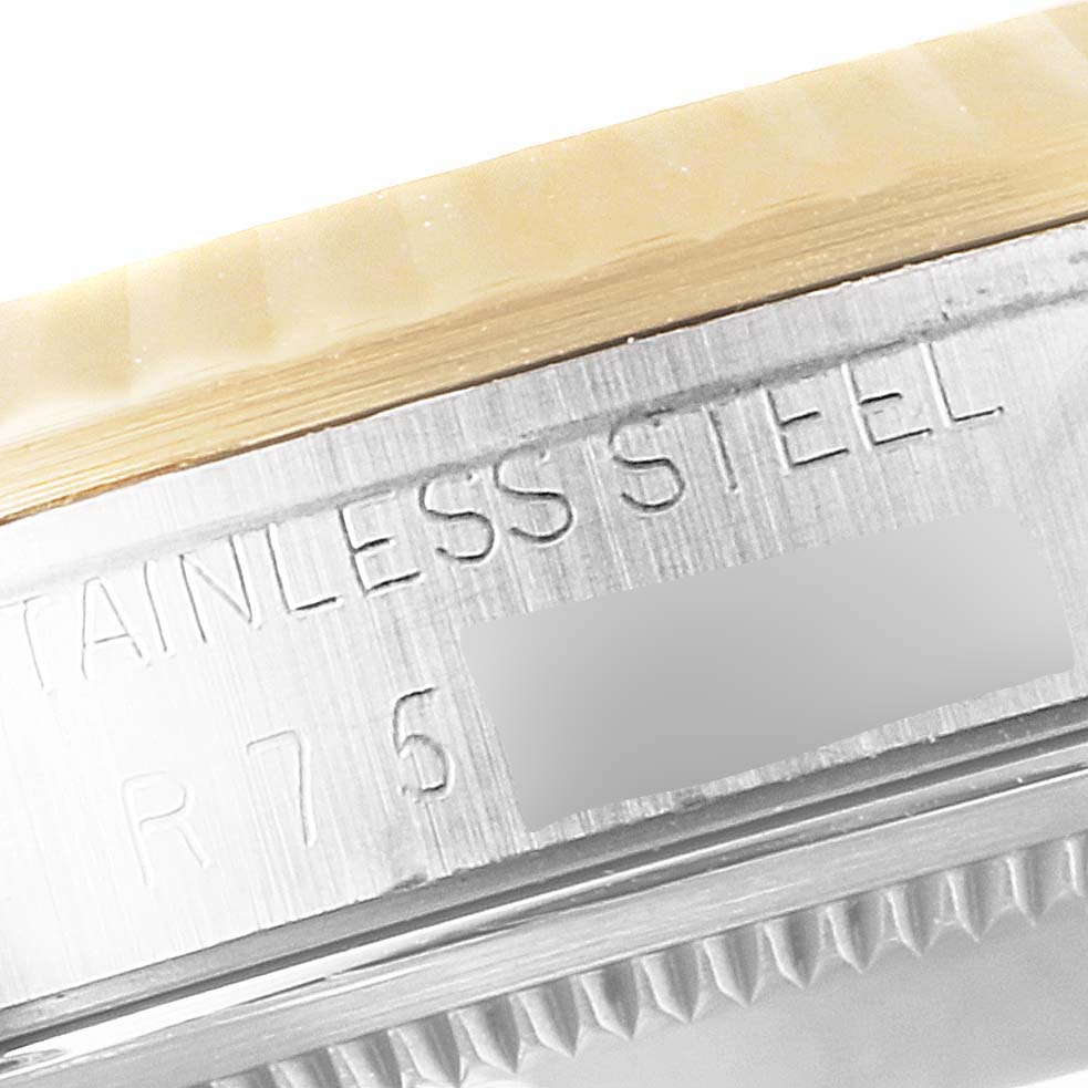 The image shows a close-up of the stainless steel case side with engraved text of a Rolex Datejust 16233 Men's Steel and Gold (two tone) Champagne Dial 16233 Men's Steel and Gold (two tone) Champagne Dial watch.