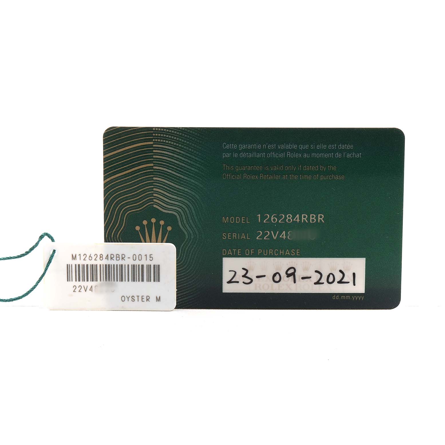 The image shows a warranty card and tag for the Rolex Datejust 126284 Men's Stainless Steel Pink Dial model, detailing the serial and model numbers.