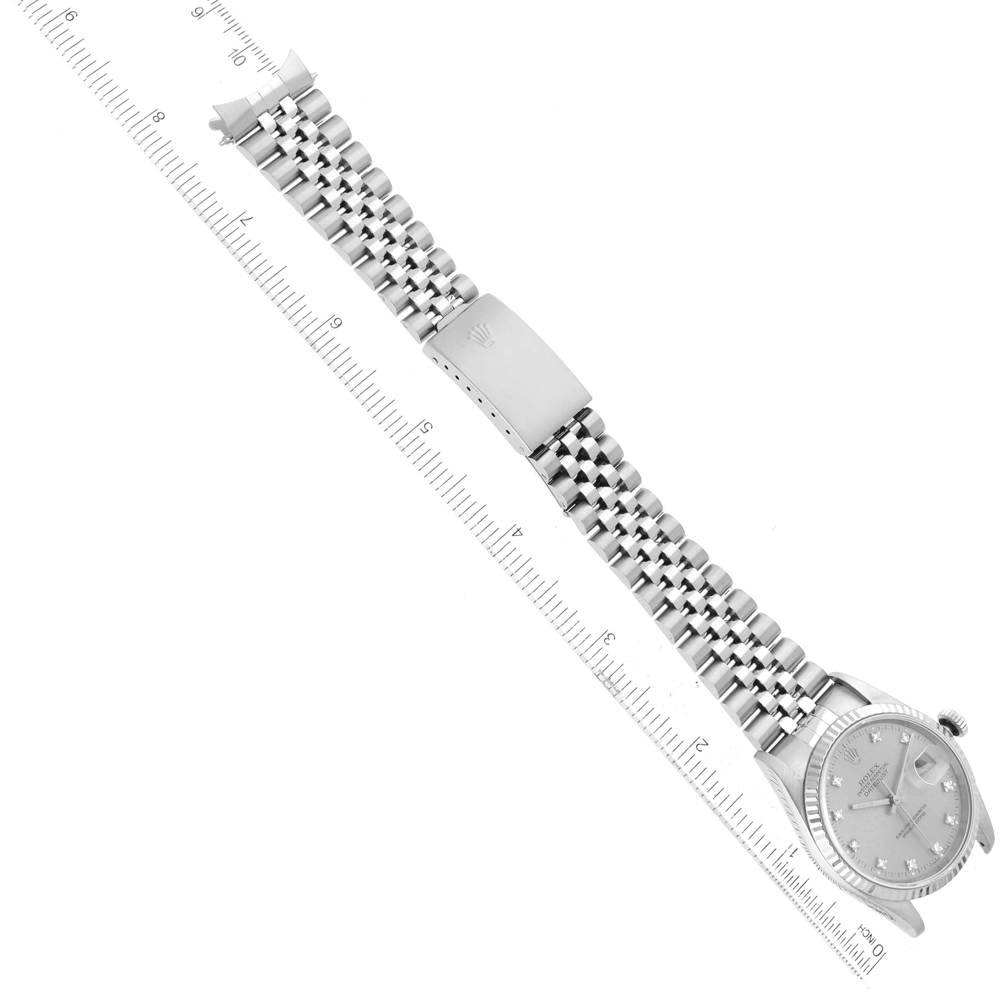The image shows a Rolex Datejust 16234 Men's Stainless Steel Silver Dial 16234 Men's Stainless Steel Silver Dial watch laid flat with its bracelet extended, alongside a ruler for scale.