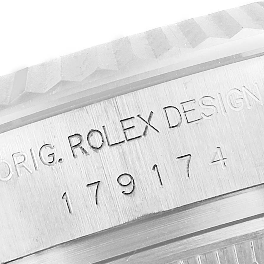 The close-up image shows the engraved case side of a Rolex Datejust 179174 Women's Stainless Steel Black Dial 179174 Women's Stainless Steel Black Dial watch, featuring the serial number and "ROLEX DESIGN."