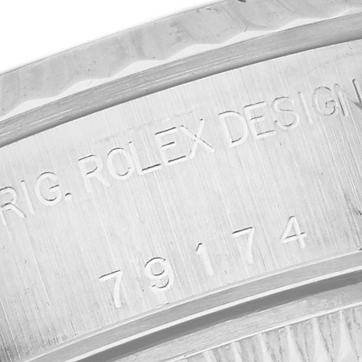 The image shows a close-up of the engraved text on the case back of a Rolex Datejust 79174 Women's Stainless Steel Silver Dial 79174 Women's Stainless Steel Silver Dial watch.